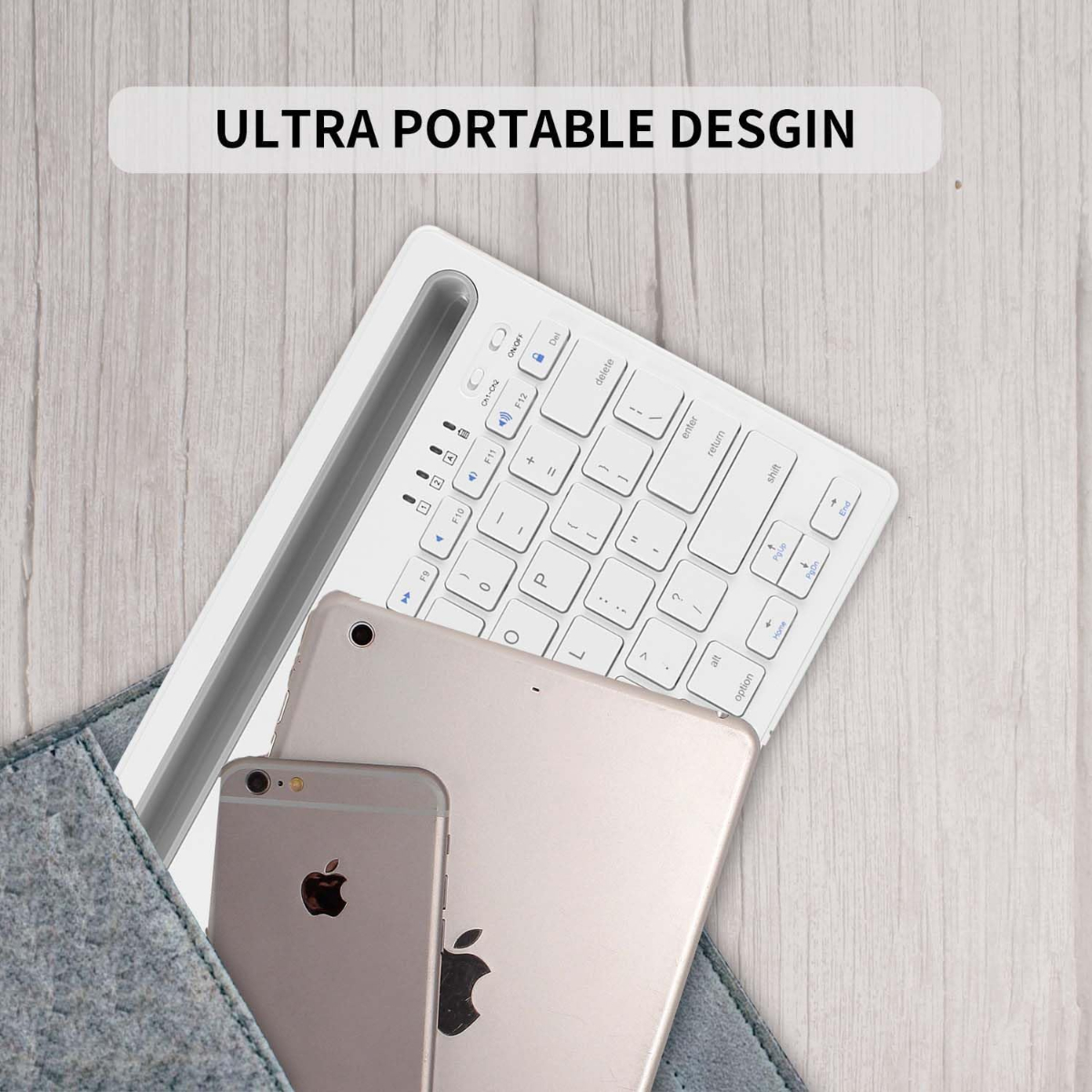 Teclado portátil blanco, una tableta y un teléfono dentro de una funda gris, sobre madera.