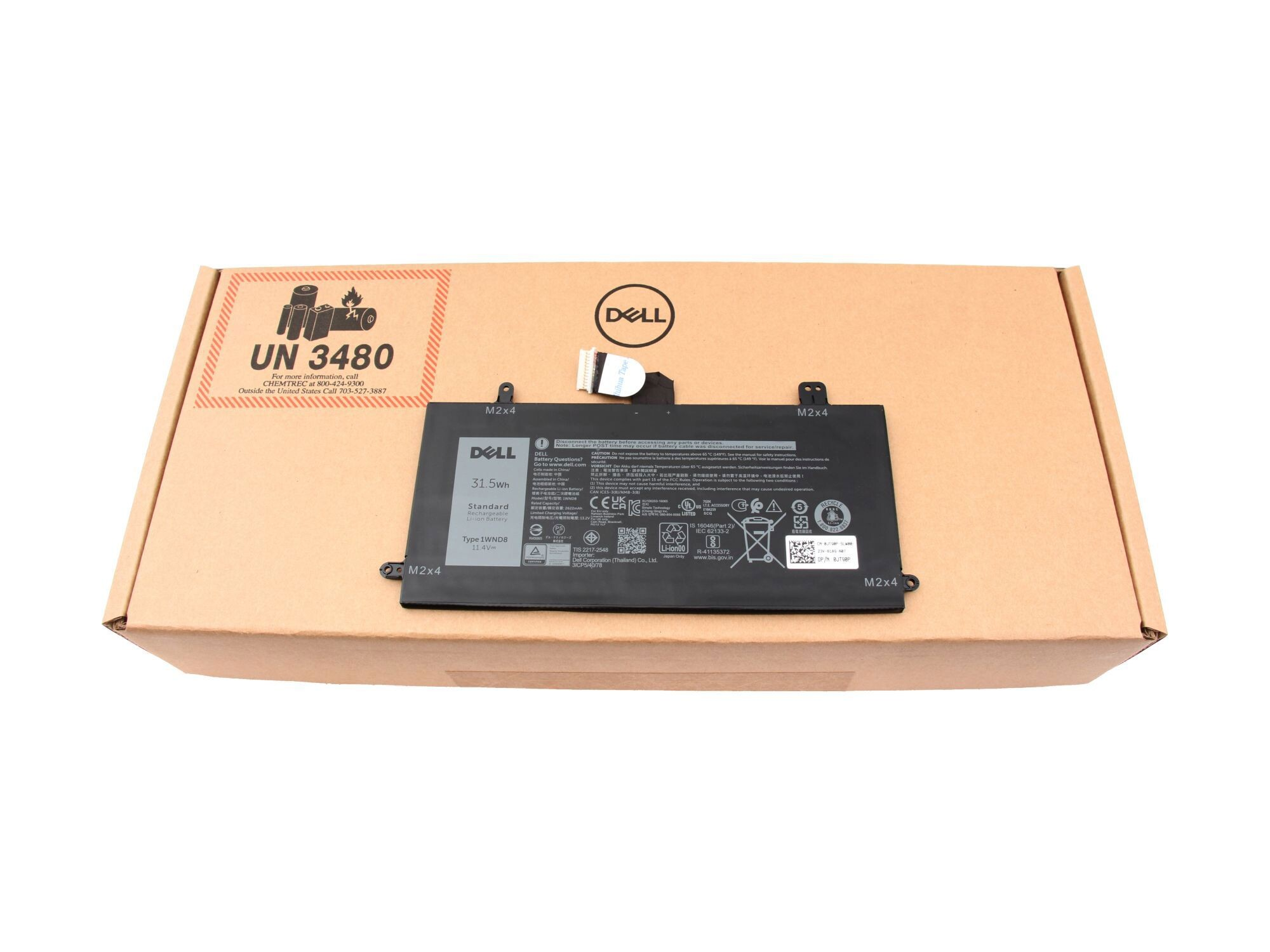 Dell Laptop-Akku in einem Karton, Etiketten und Stecker sichtbar.