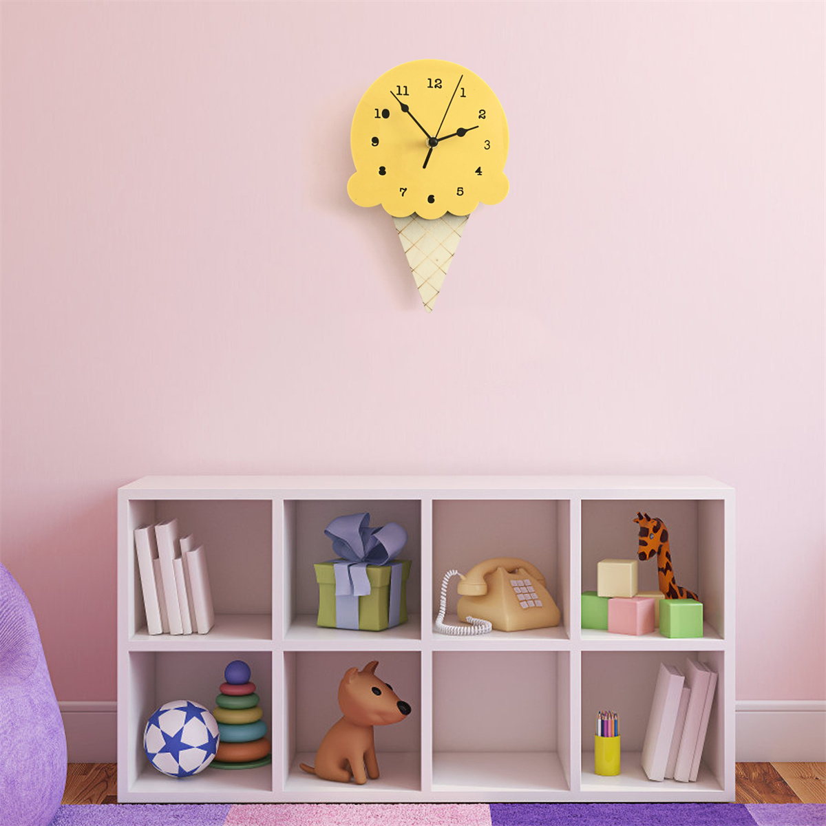 Eine gelbe Eistütenuhr an einer rosa Wand, mit Spielzeug auf einem weißen Regal.