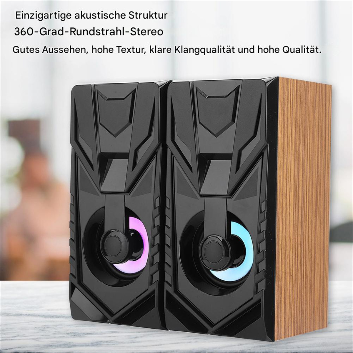 Schwarze und holzmaserierte Lautsprecher mit bunten, beleuchteten Kreisen. Text beschreibt Merkmale.