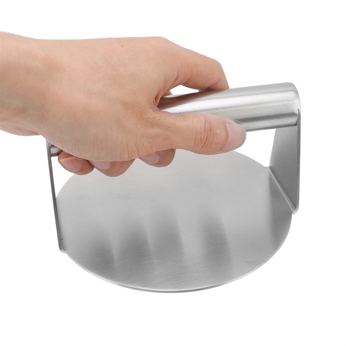 Hand hält eine Burgerpresse aus Metall. Weißer Hintergrund.