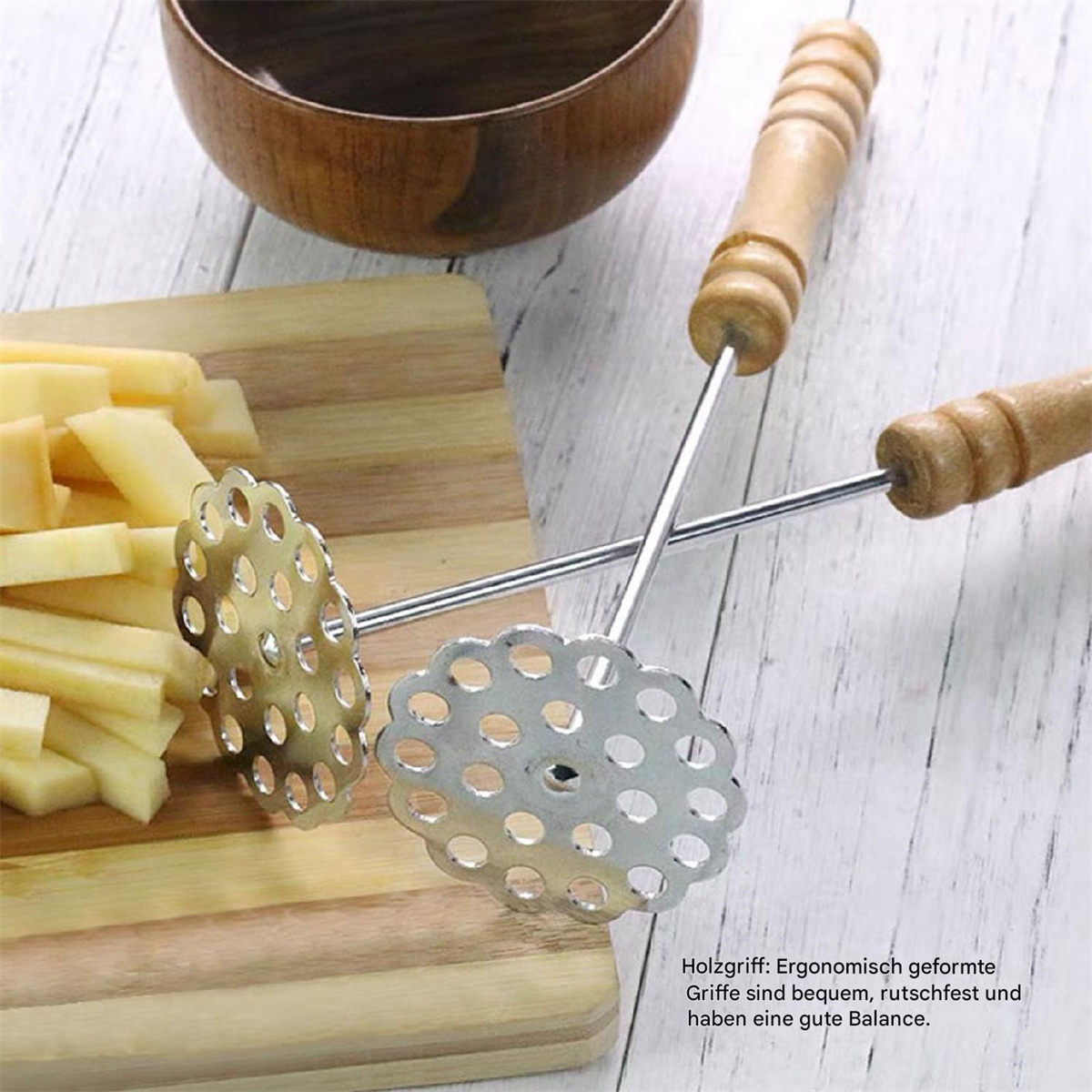Zwei Kartoffelstampfer auf Holzbrett mit geschnittenen Kartoffeln.