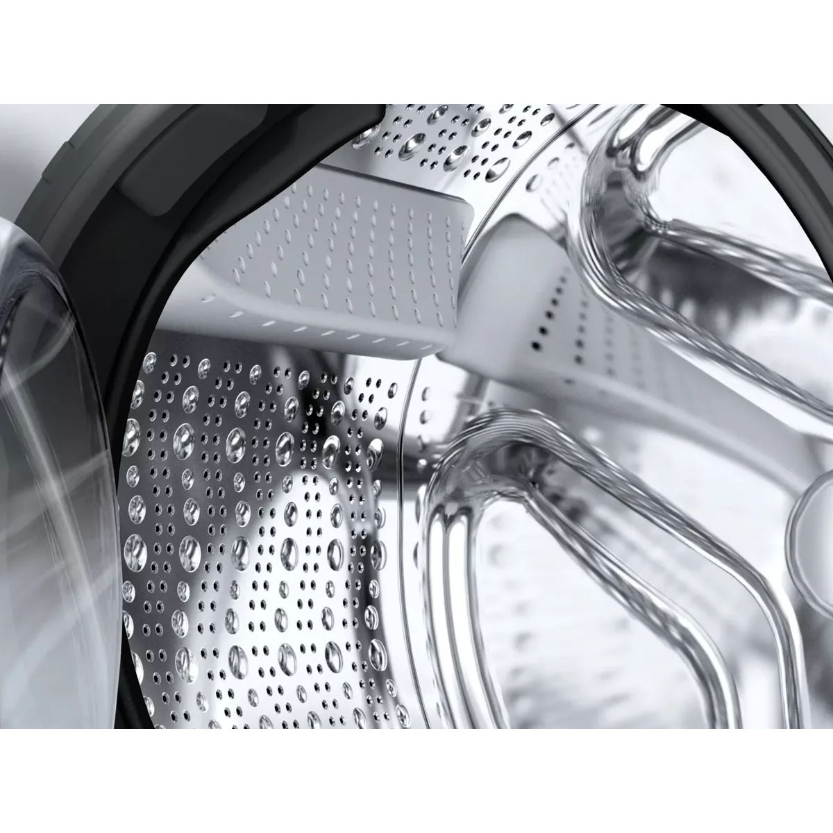Gros plan de l'intérieur d'un tambour de machine à laver. Acier inoxydable et gouttes d'eau.