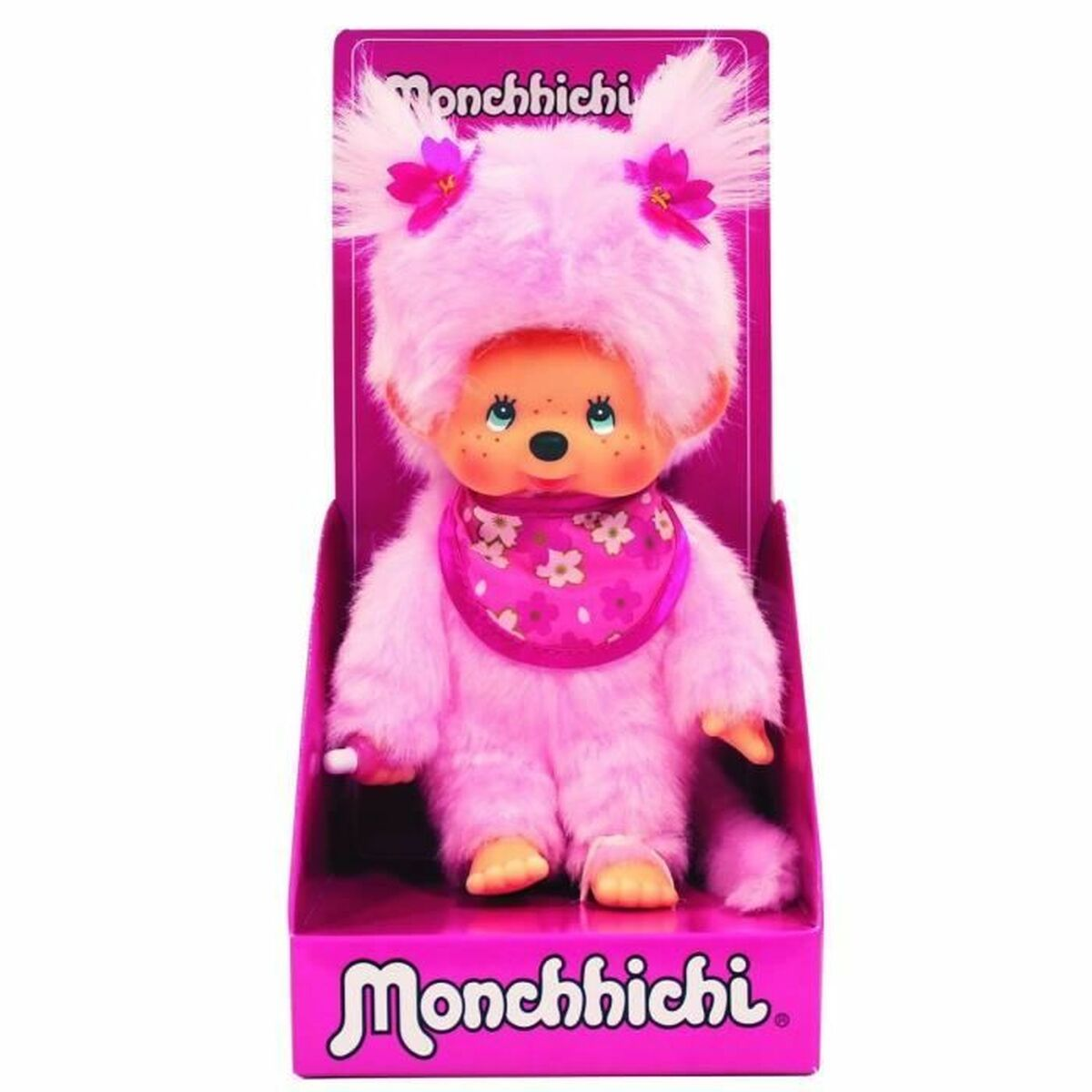 Różowa lalka Monchhichi w pudełku, z różowym opakowaniem.