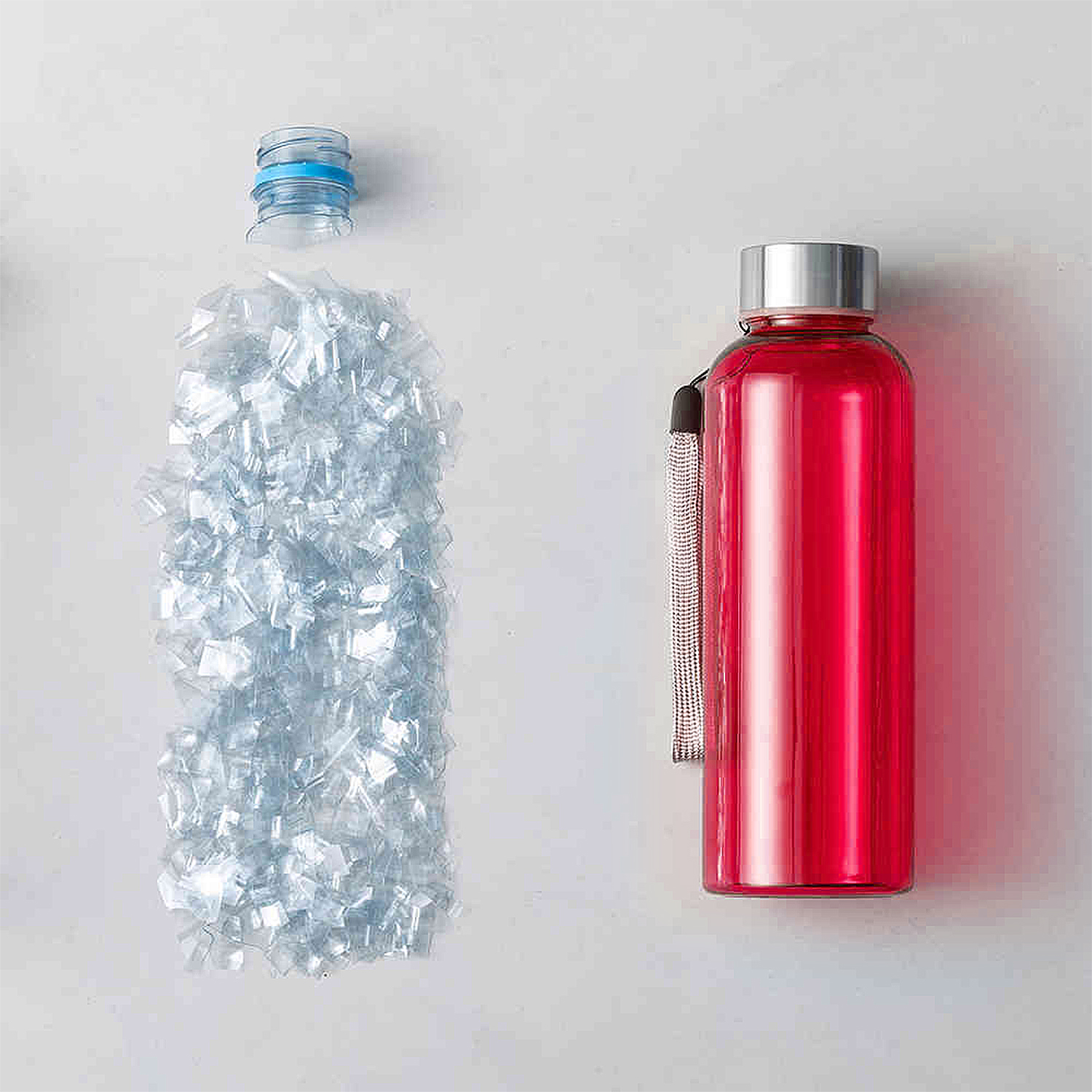 Dos botellas de agua: una de plástico en trozos, una metálica roja con correa.