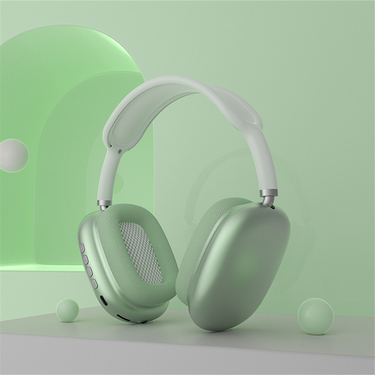 Grüne Kopfhörer. Stilvolles Design, hellgrüne Farbe. Minimalistischer Hintergrund mit Kugeln.