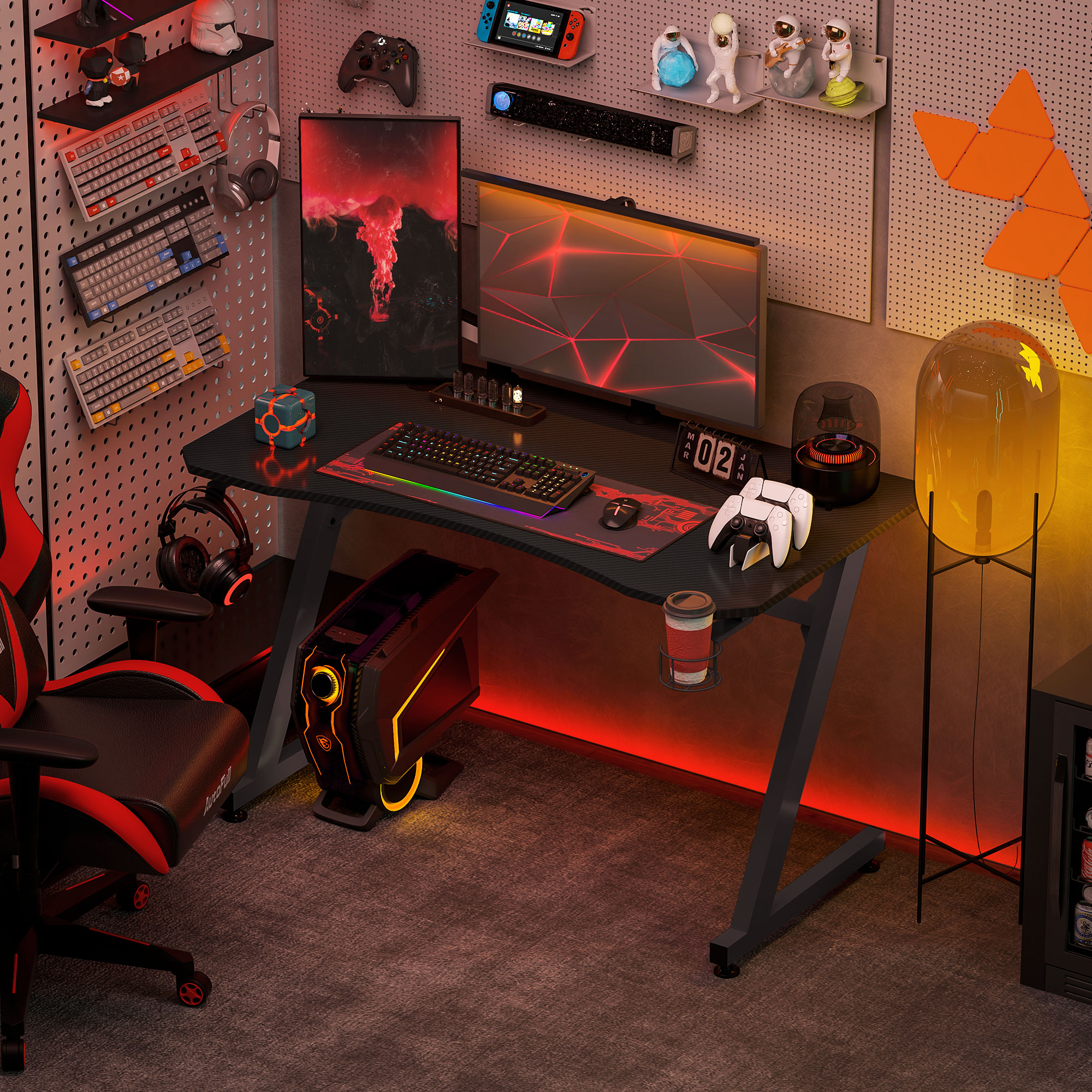 Configuración de juego con escritorio rojo y negro, monitor, accesorios y silla roja.