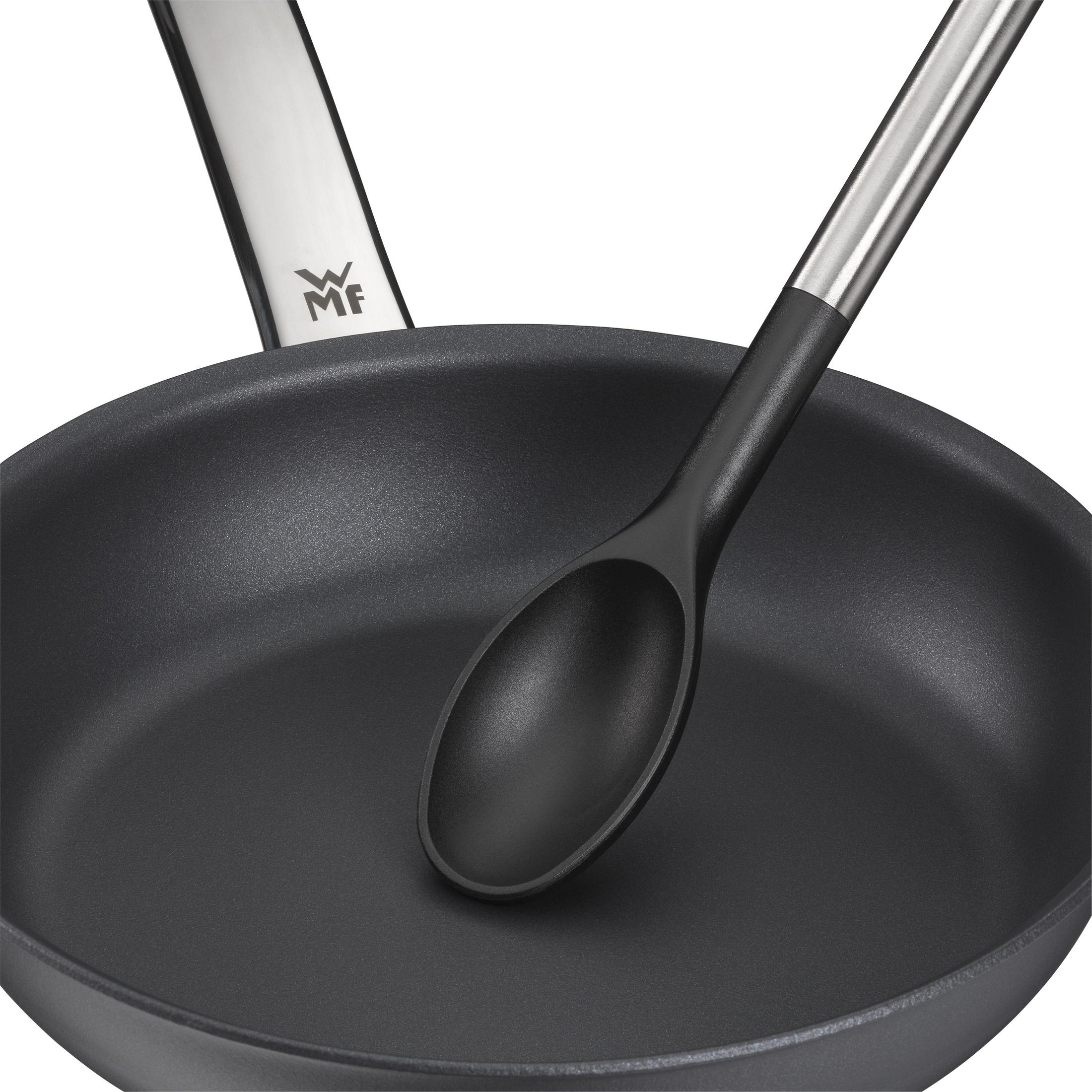 Eine schwarze Pfanne und ein schwarzer Löffel auf weißem Hintergrund. WMF-Logo auf der Pfanne.