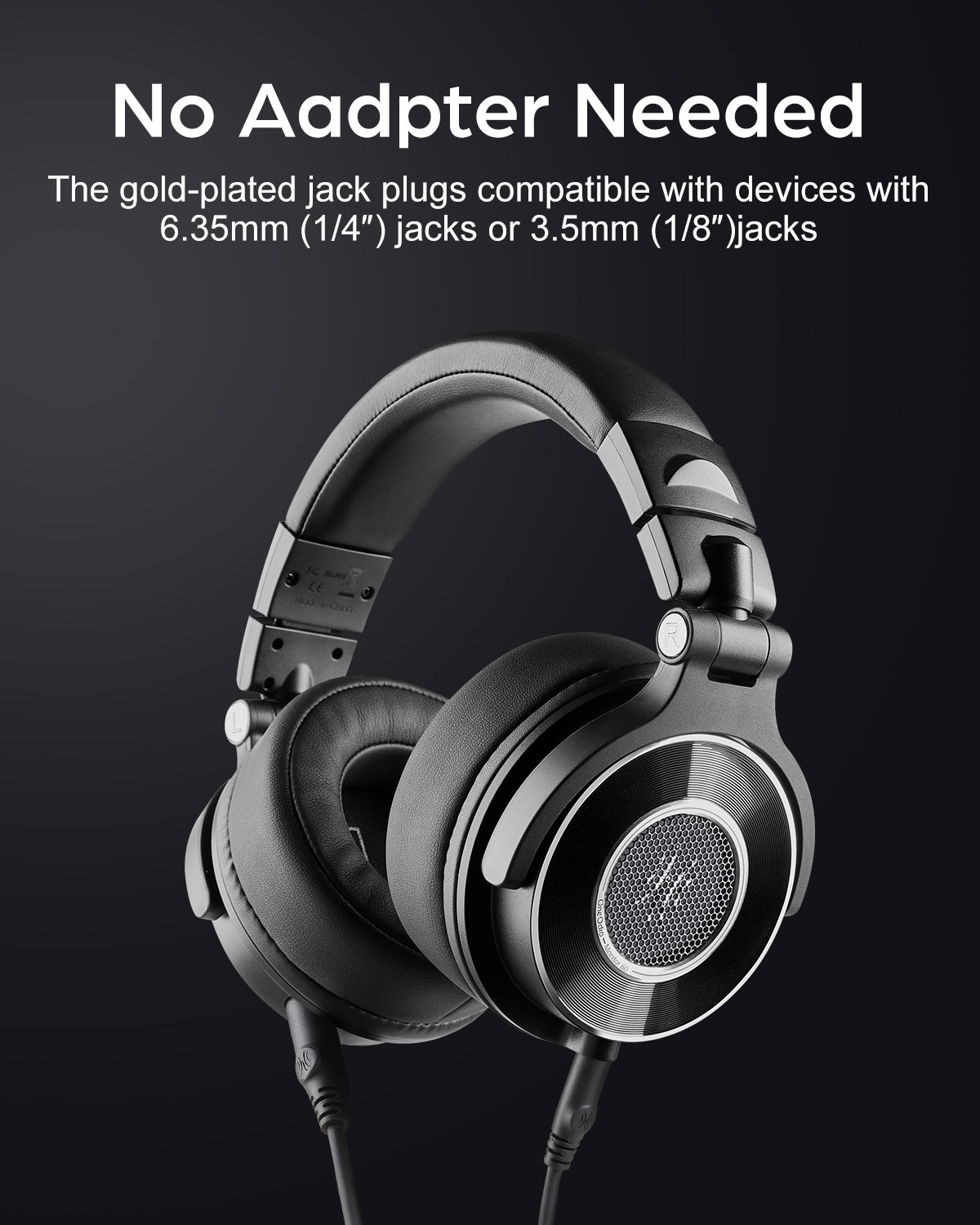 Black headphones with gold-plated jack plugs, close-up on black background.