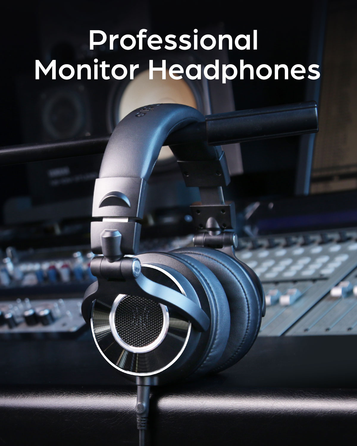 Black headphones. Black headphones with a black cable, in front of a sound mixing setup.