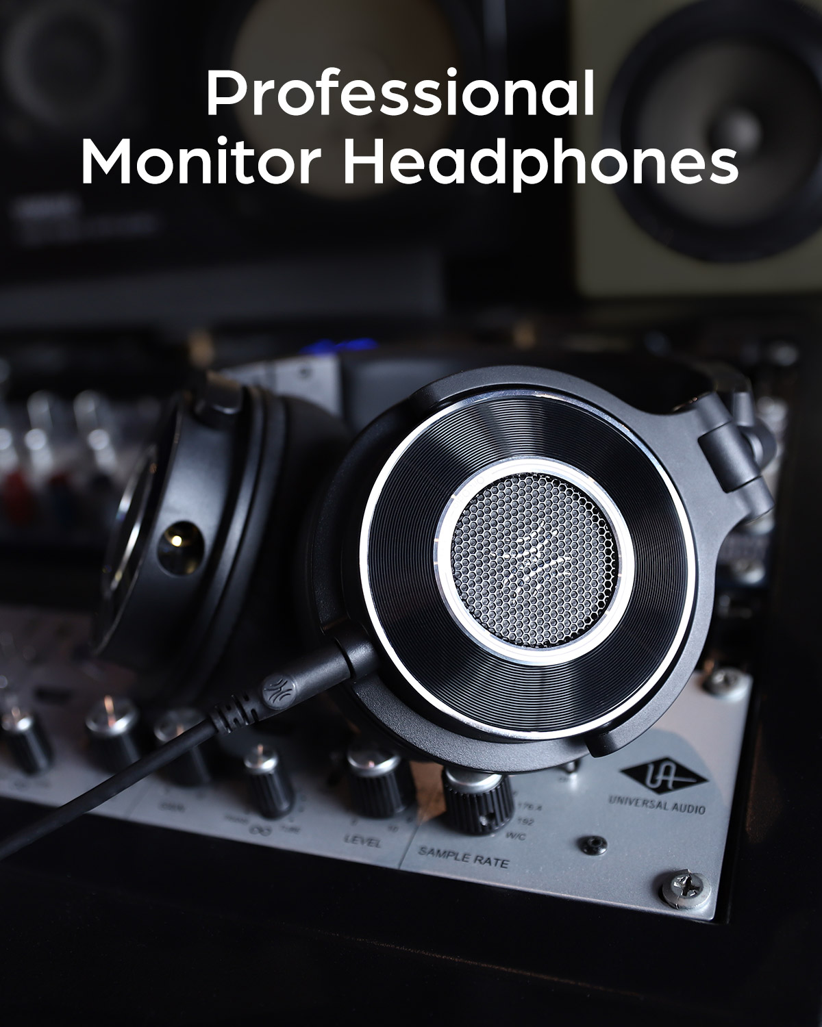 Professional monitor headphones on an audio mixing console. Headphones are black and silver in color.