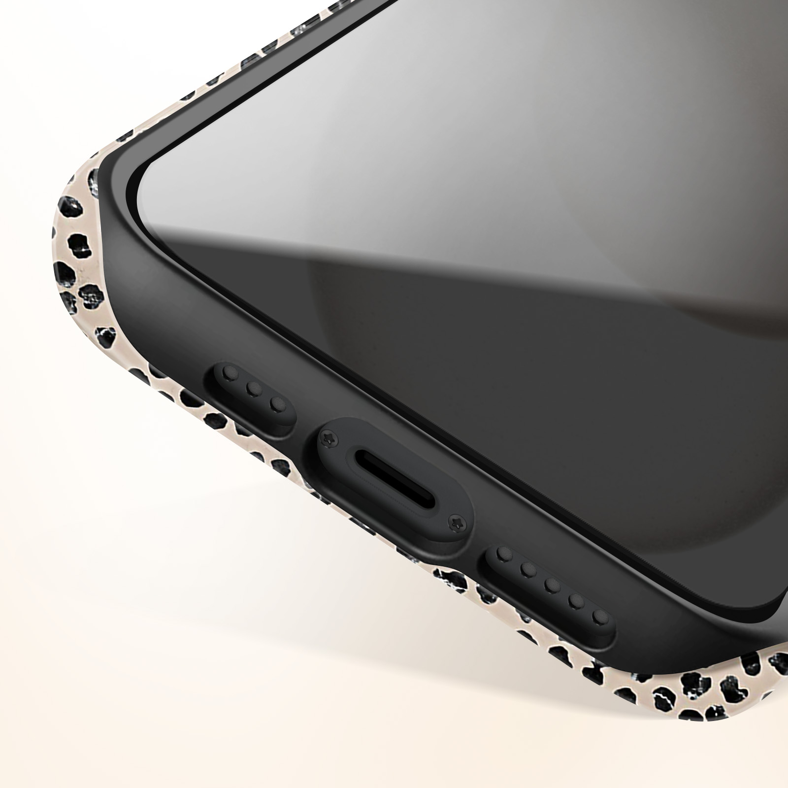 Close-up of phone case with black and cream dalmatian pattern.