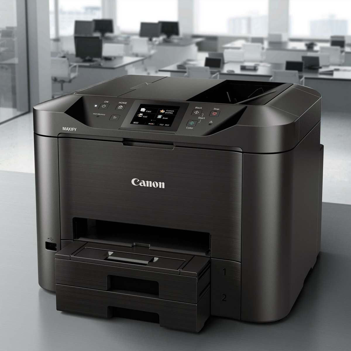 Stampante Canon MAXIFY nera su una scrivania grigia in un ufficio.