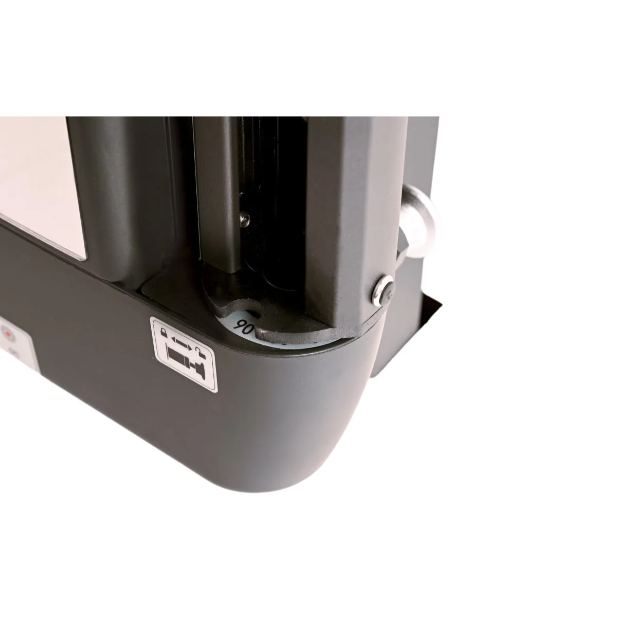 Close-up van een zwart object met een draaiknop en een sticker met een camera-icoon.