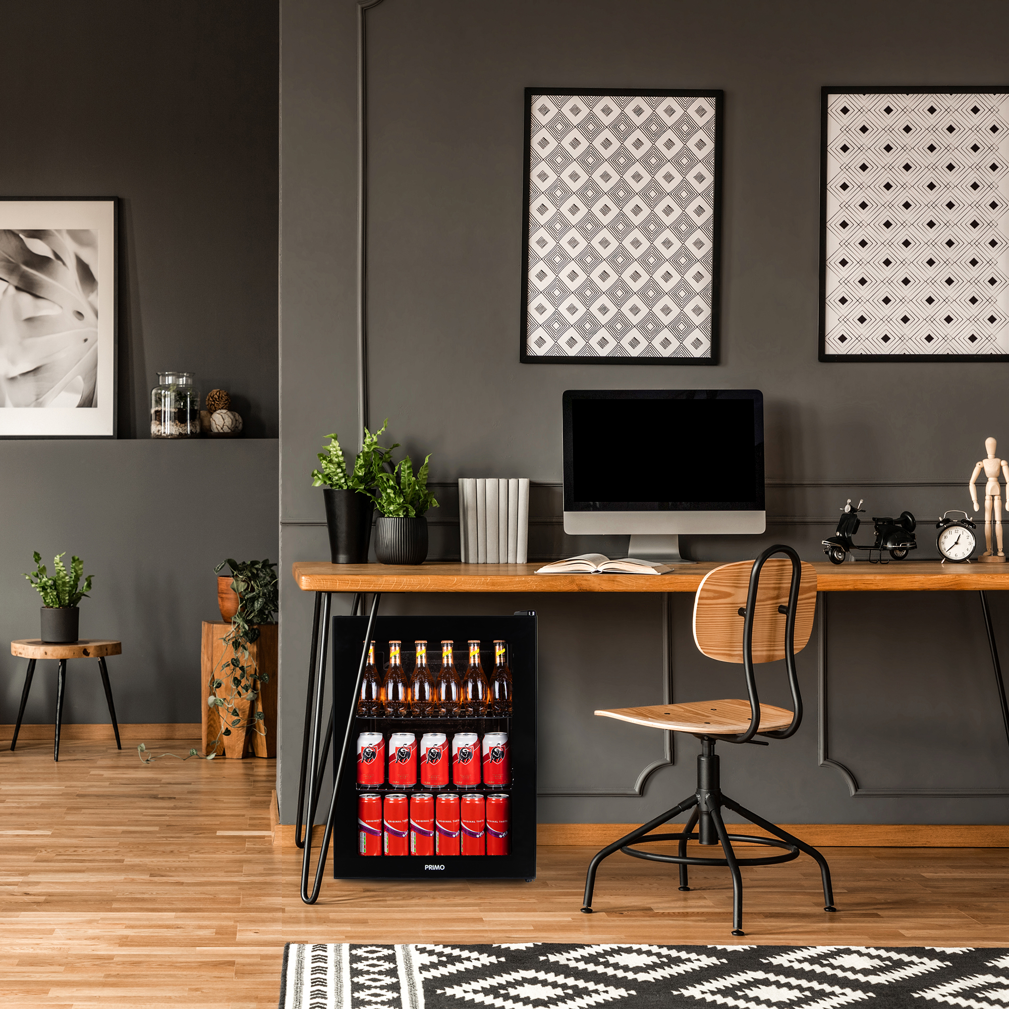 An office with a mini-fridge, desk, computer, chair, and decorative items.