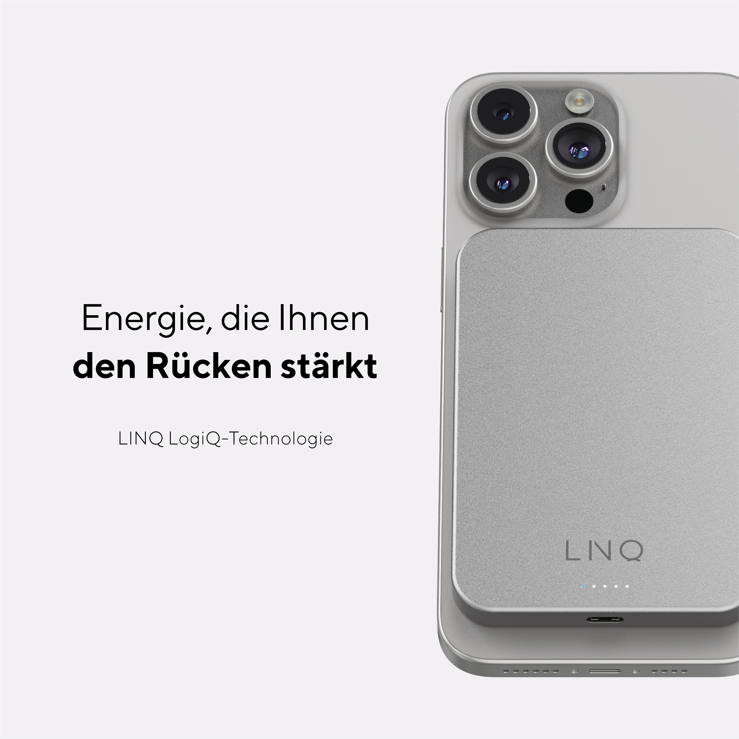 Silbernes Telefon mit einem silbernen Ladeblock. Das Telefon hat schwarze Kameralinsen.