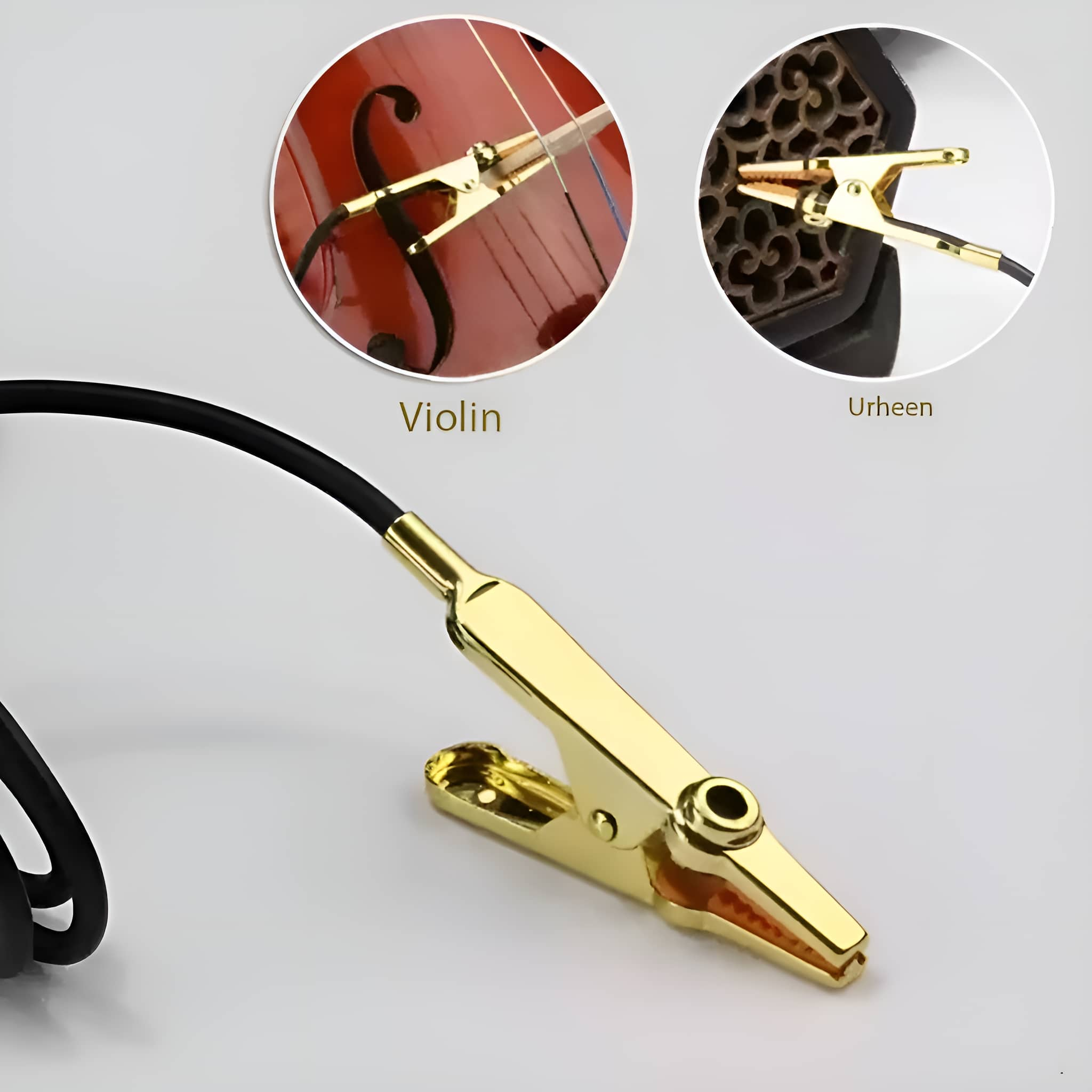 Eine goldene Klammer, um eine Violine und eine chinesische Violine (Erhu) zu halten. Beide Instrumente sind im Bild gezeigt.