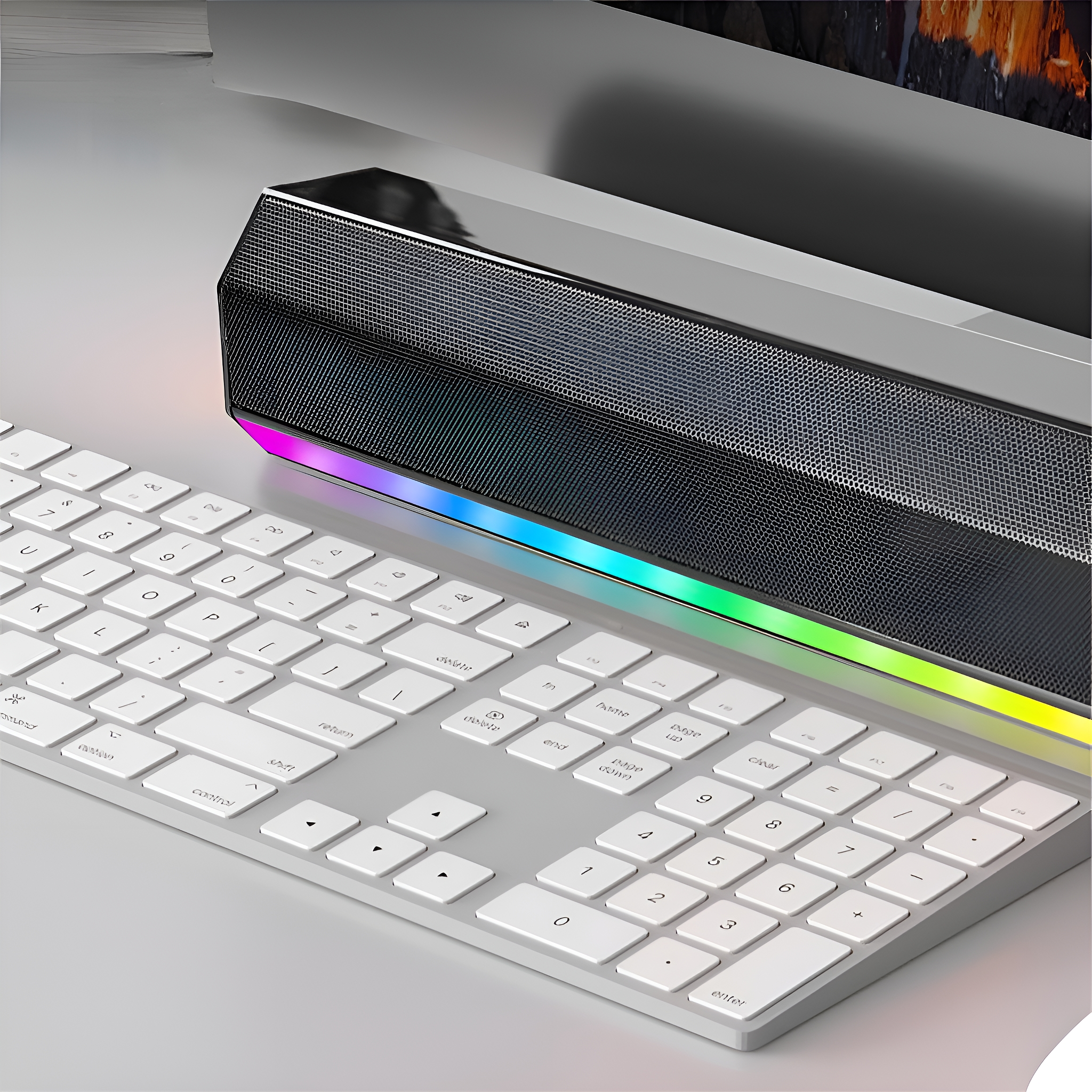 Weiße Tastatur und eine Soundbar mit farbwechselnden Lichtern. Graue Oberfläche. Modernes Setup.