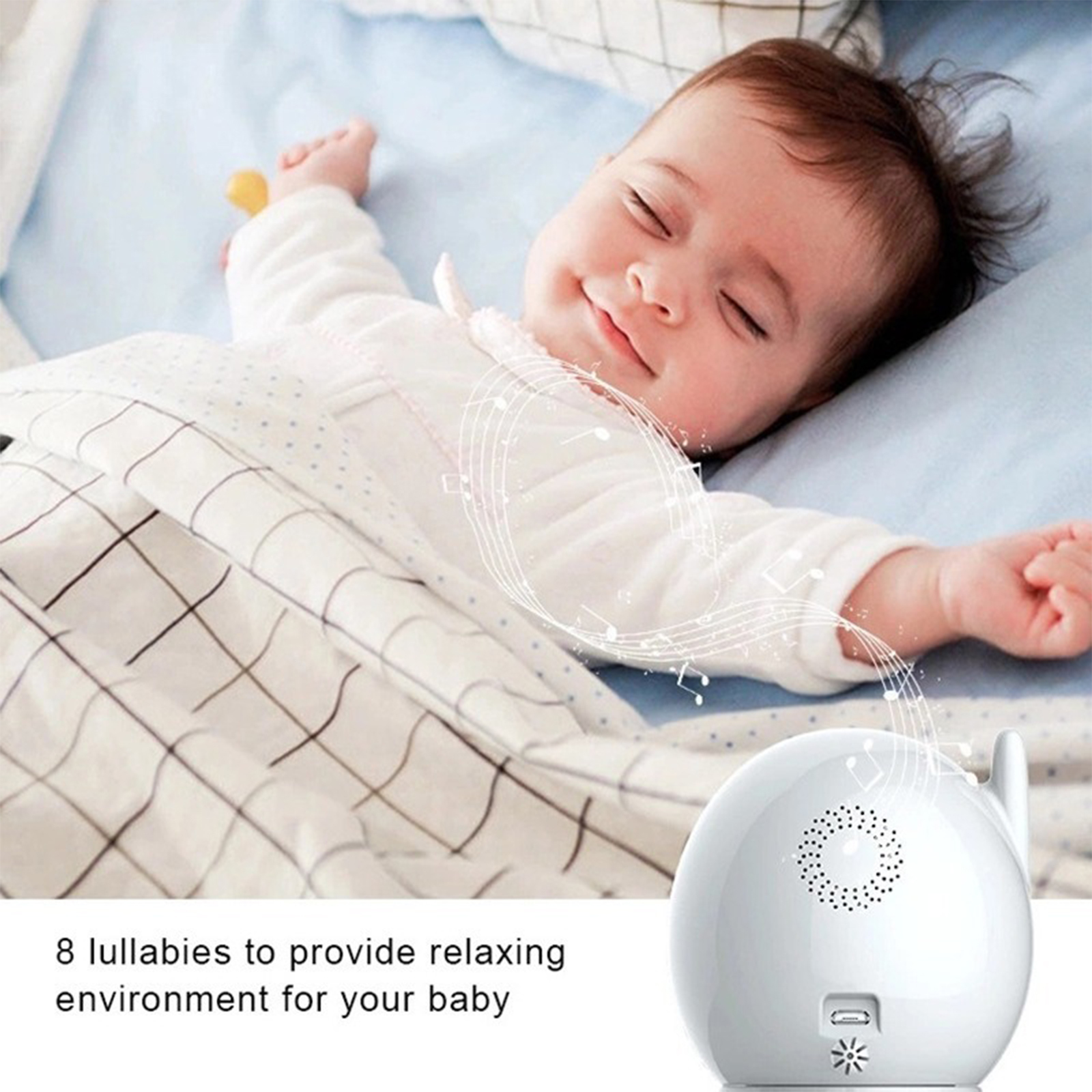 Ein Baby schläft mit Noten und einer weißen Geräuschmaschine mit Lautsprecher.