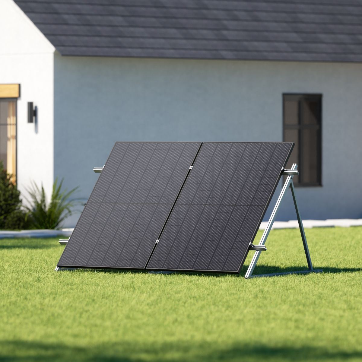 Zwei schwarze Solarmodule im Garten installiert, gestützt von einem Metallrahmen, vor einem Haus.
