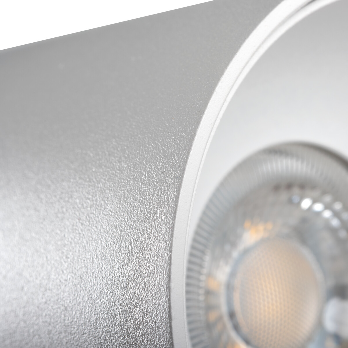 Primo piano di lampada argento. Superficie strutturata con sorgente luminosa visibile.