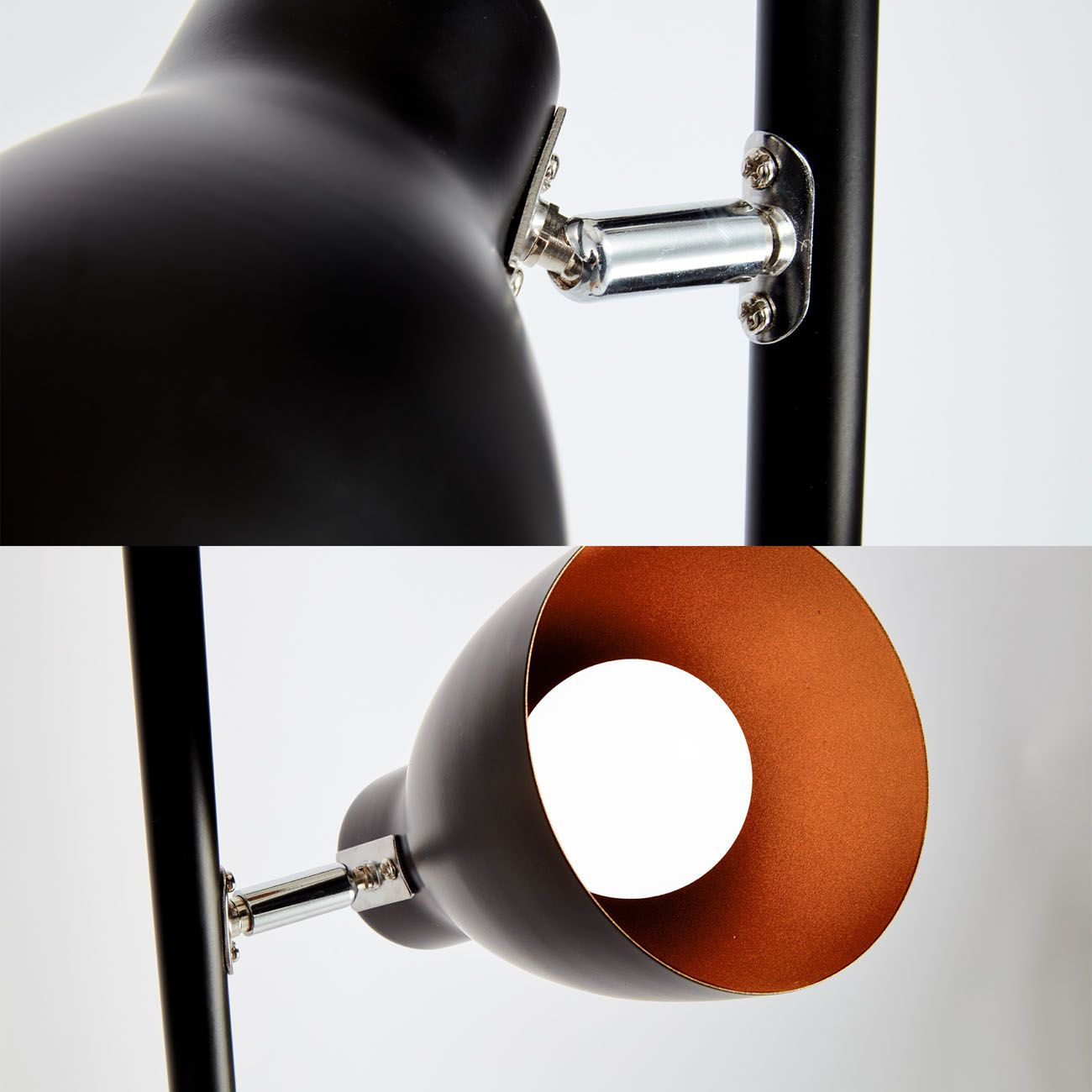 Lampada nera e bronzo con due luci. La lampadina inferiore è accesa.