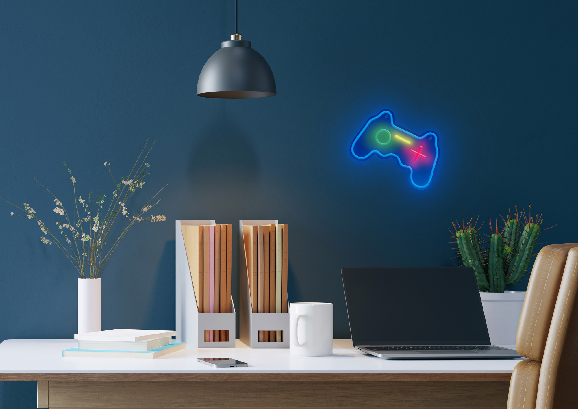 Ein Schreibtisch mit Laptop, Tasse, Büchern und einem Neon-Gaming-Controller an einer blauen Wand.