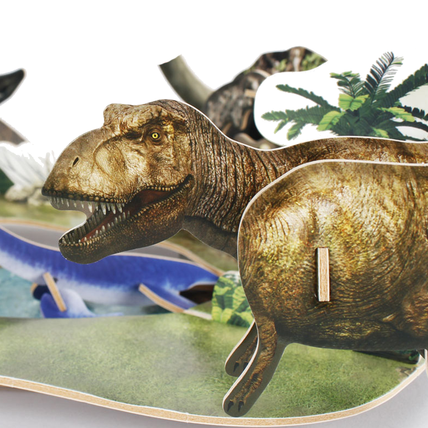 Rompecabezas de dinosaurios con un T-Rex y otros dinosaurios en un paisaje verde.