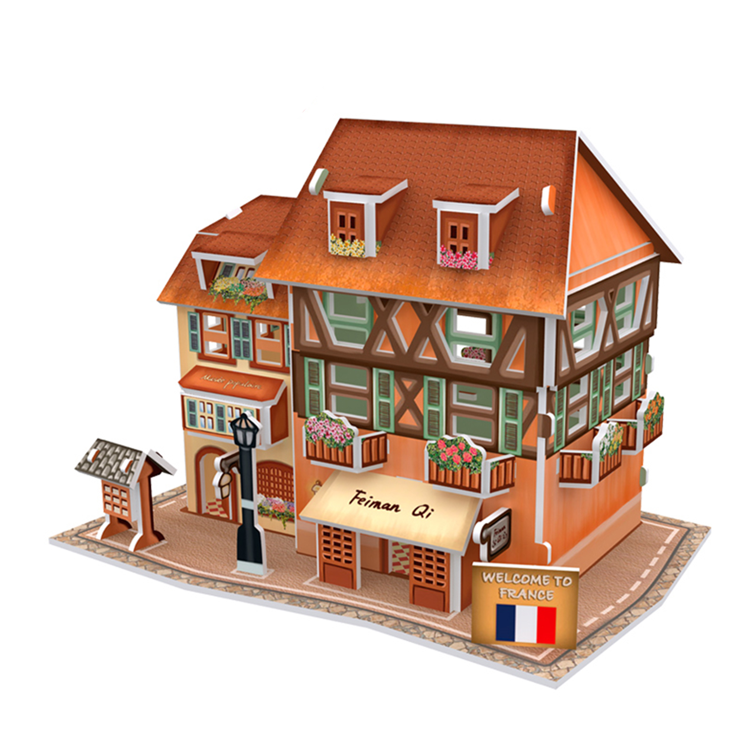Ein farbenfrohes Modellhaus mit orangefarbenem Dach, Fenstern und einem Schild mit der Aufschrift 'Welcome to France'.