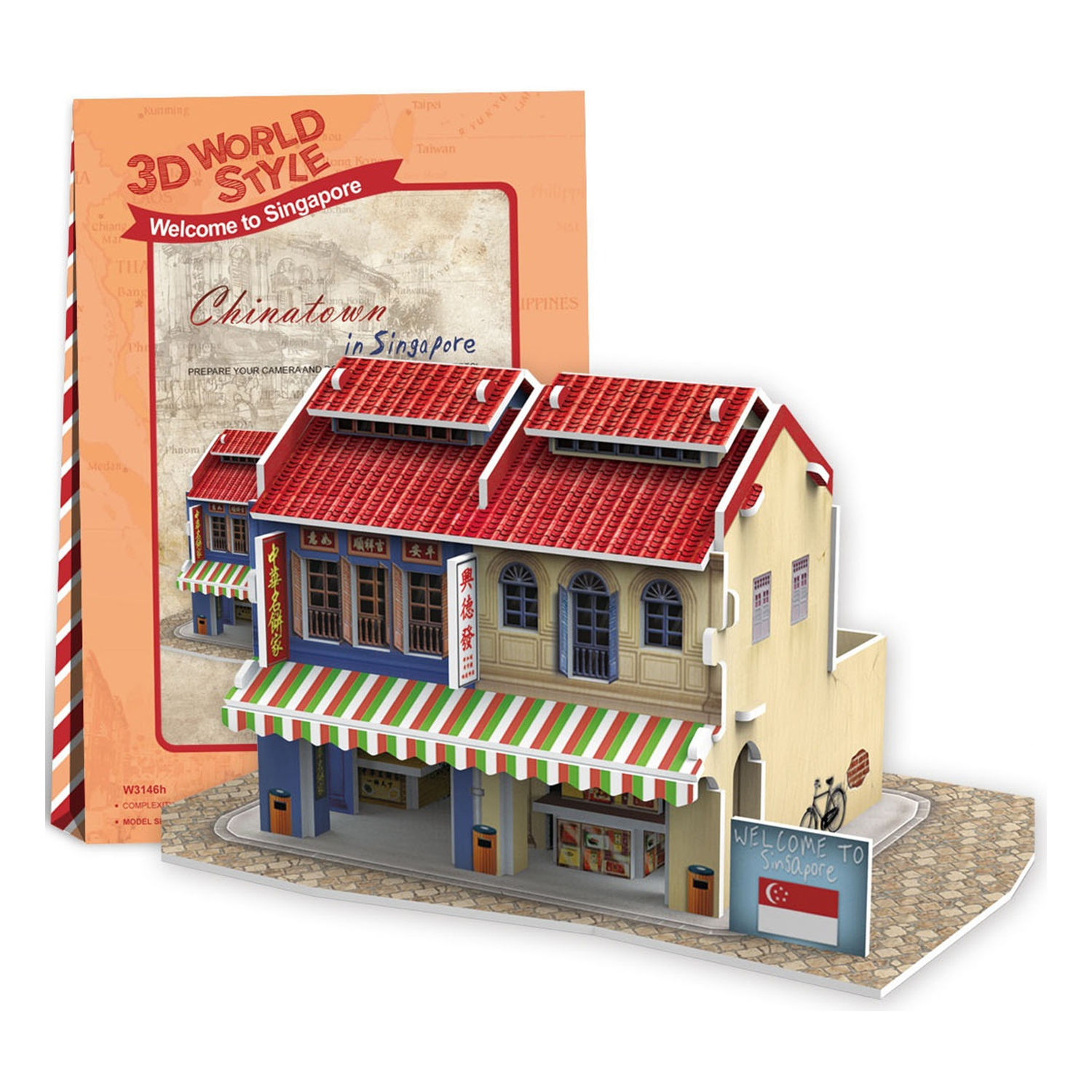 Ein Miniaturmodell eines Chinatown-Gebäudes in Singapur, mit einem Buch daneben.