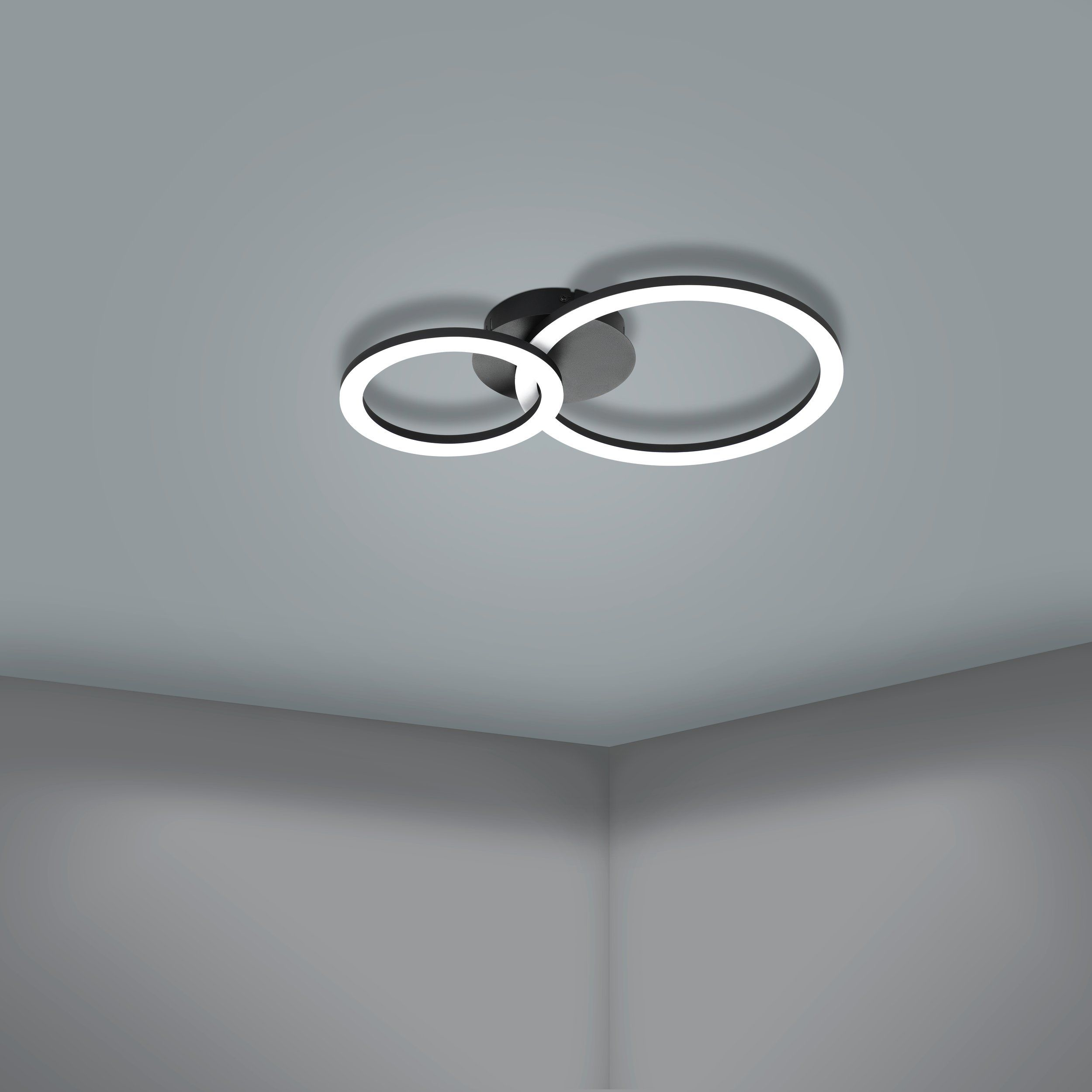 Due luci circolari nere montate su un soffitto grigio.