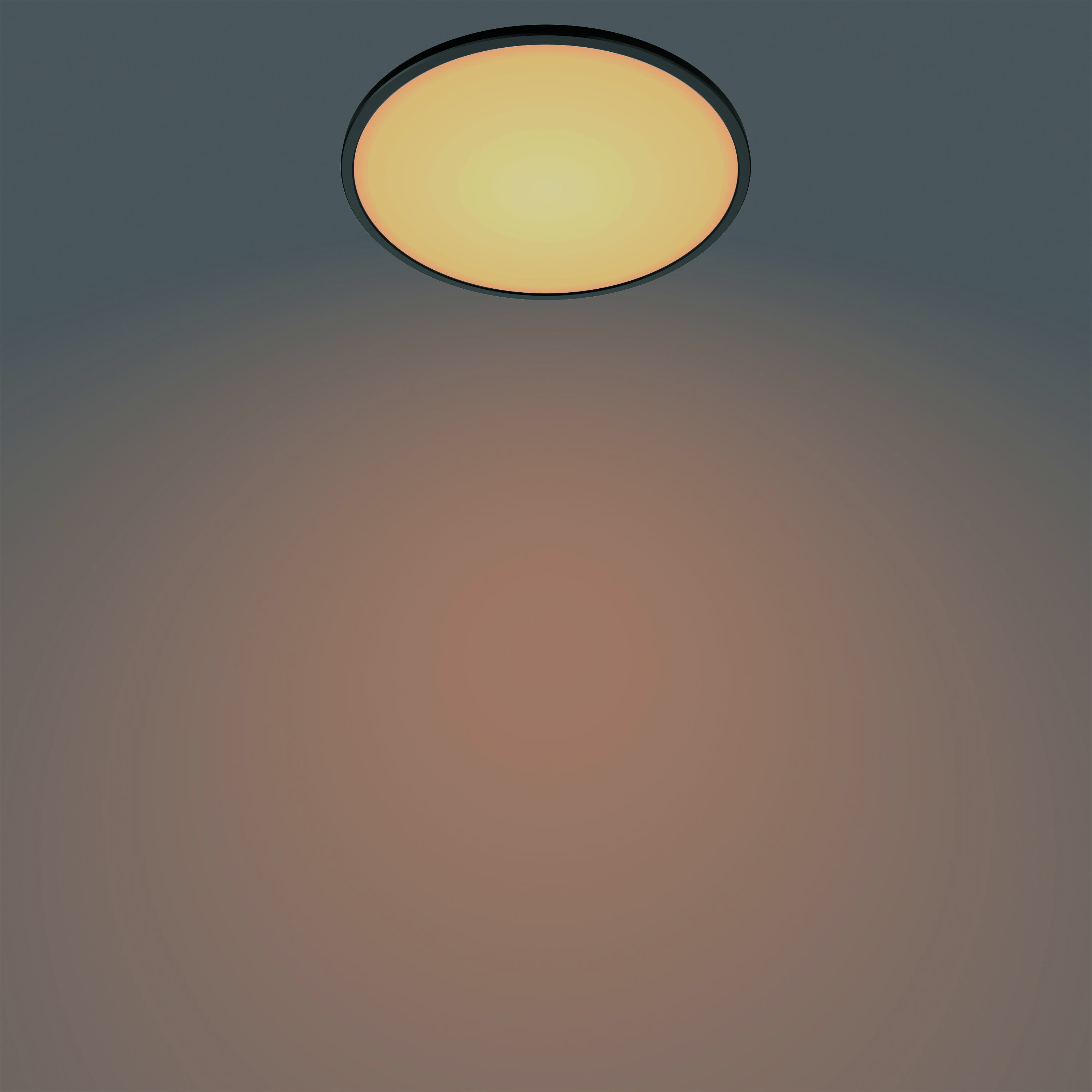 Plafonnier rond et dimmable avec cadre noir, émettant une lueur jaune chaude.