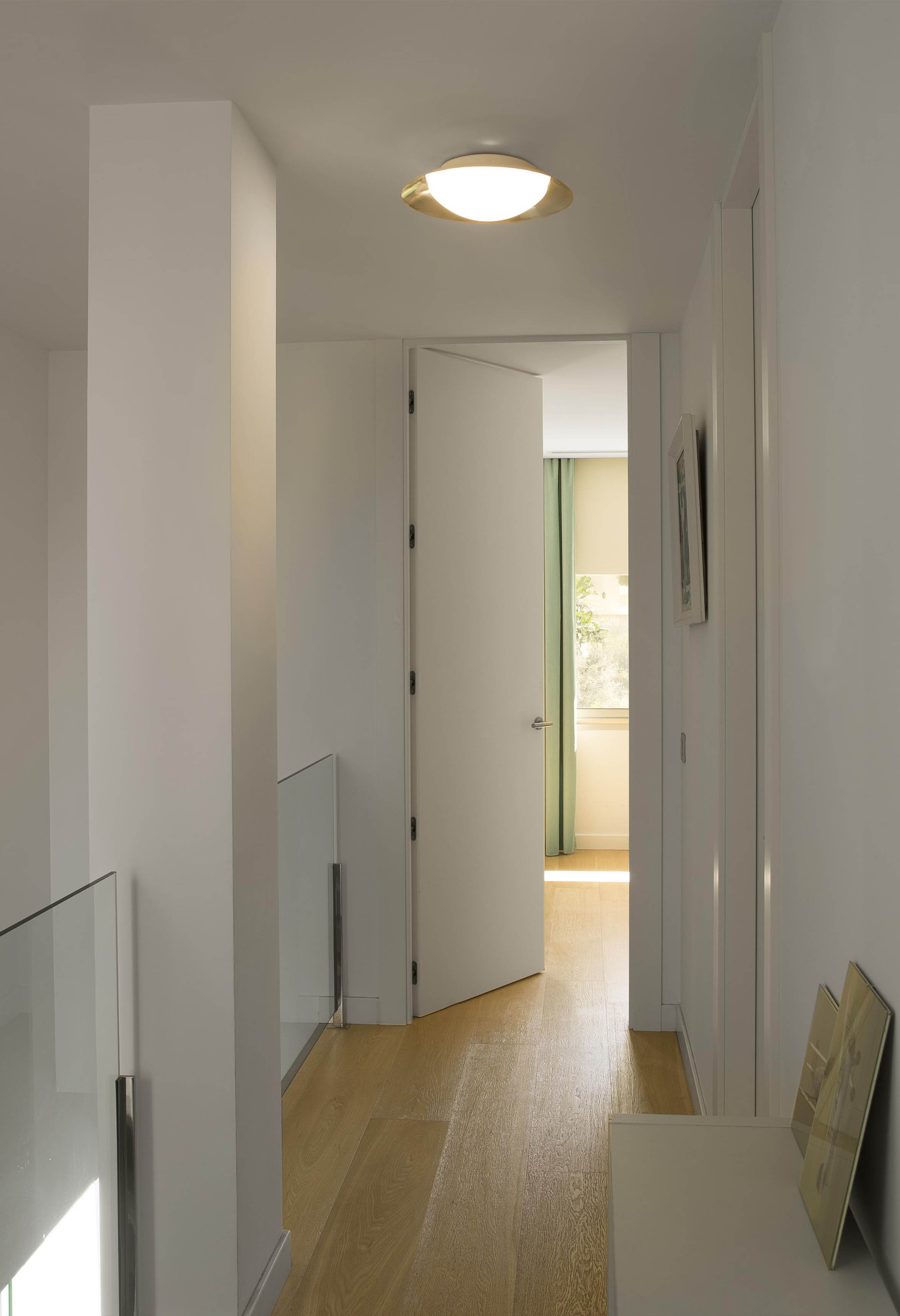 Interieur van gang met open deur naar een kamer.