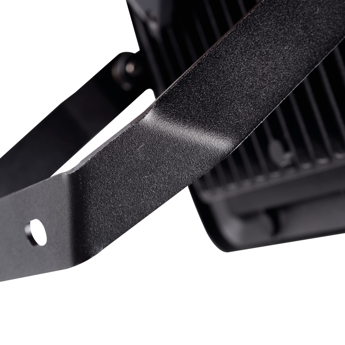 Close-up of the back of a black floodlight showing the bracket and the finned heat sink.