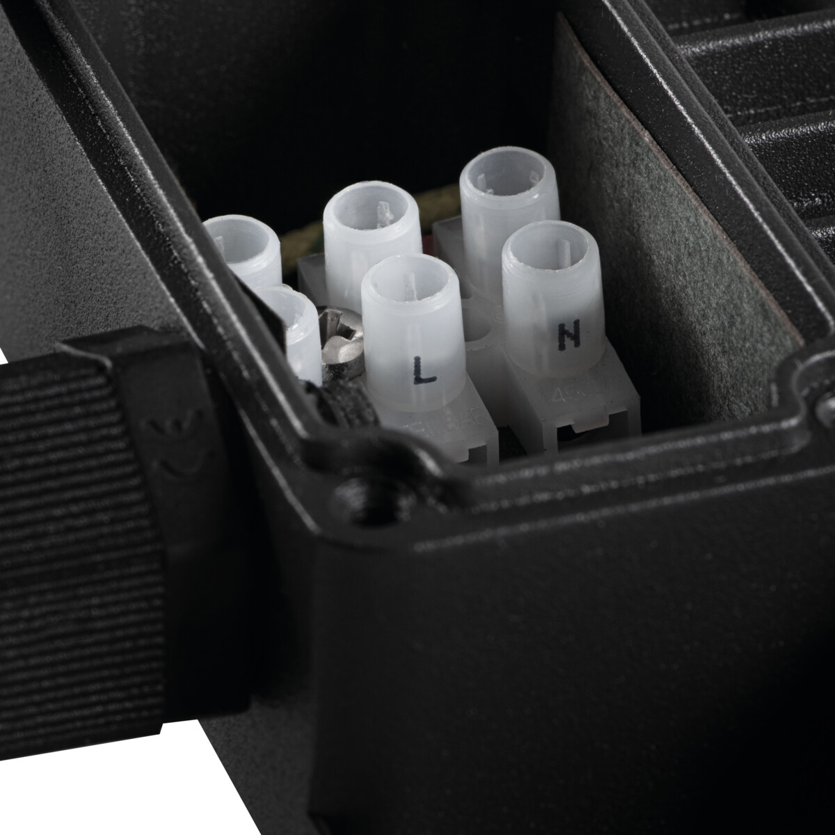 Close-up of electrical terminals inside a black junction box, with labeled connections.