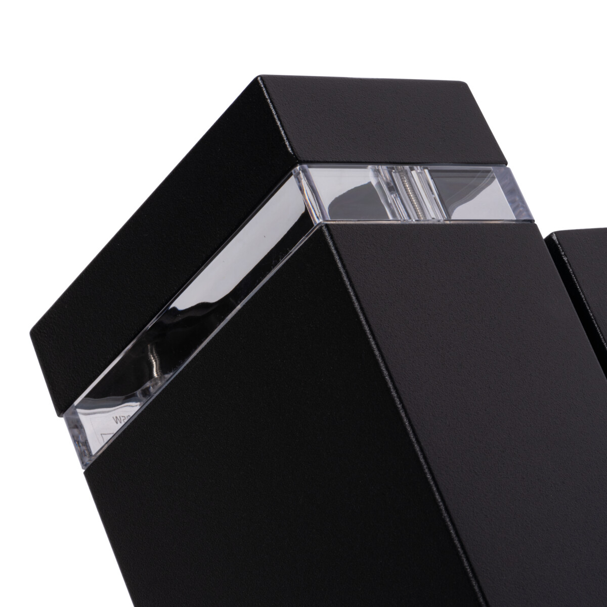 Close up of a black light with a clear glass panel and silver accents. The background is white.