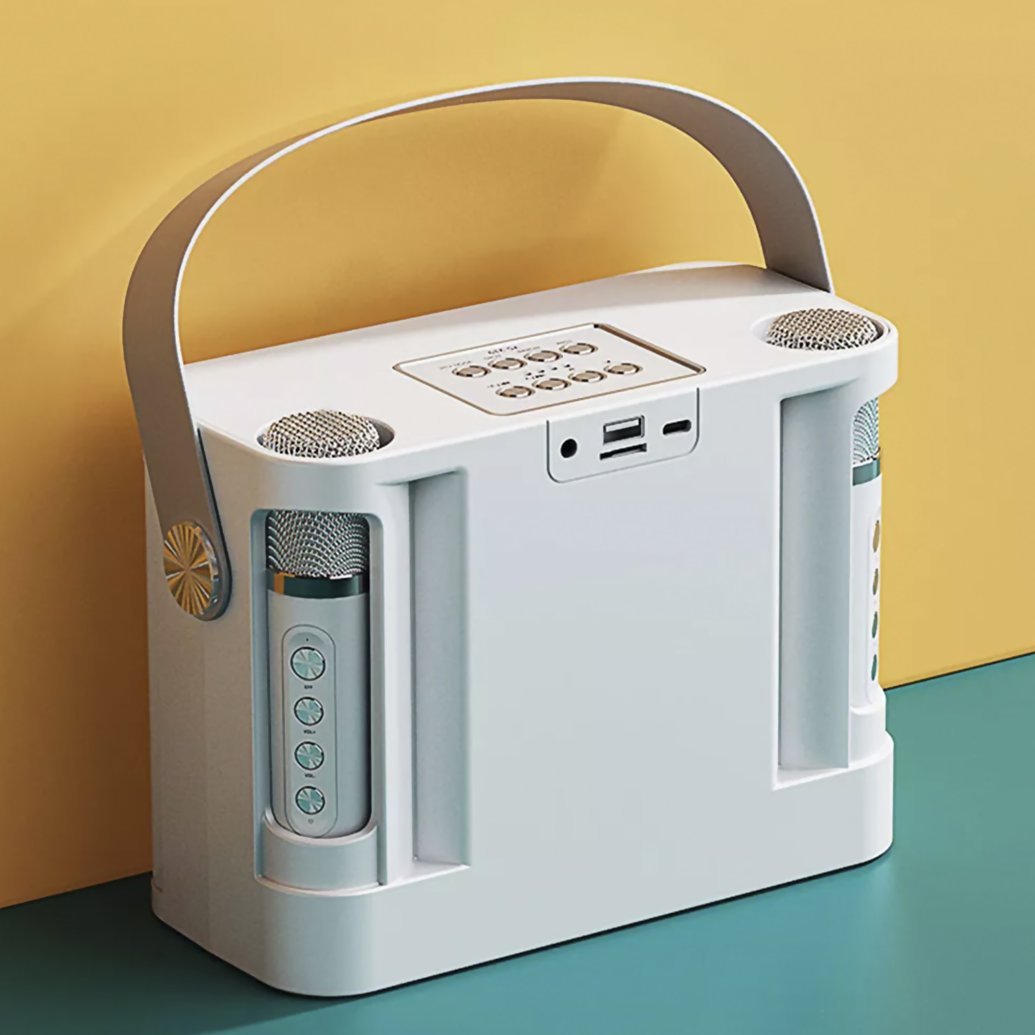 Máquina de karaoke blanca. Tiene dos micrófonos y un asa, con un fondo amarillo y verde azulado.