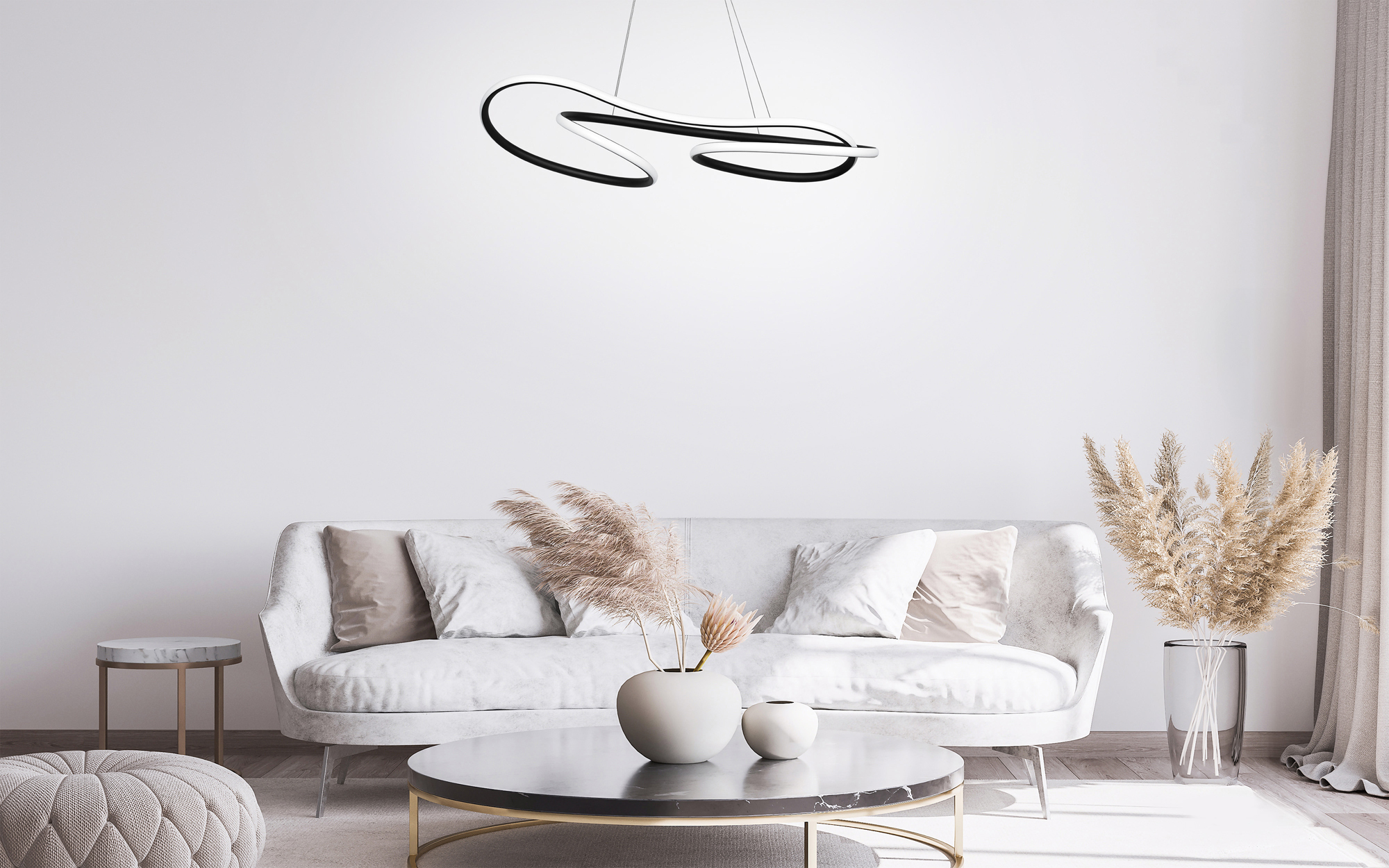 Lámpara colgante moderna blanca y negra sobre sofá y mesa de centro blancos.