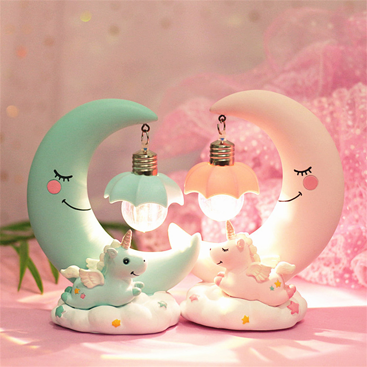 Zwei Einhorn-Lampen mit halbmondförmigen Basen.