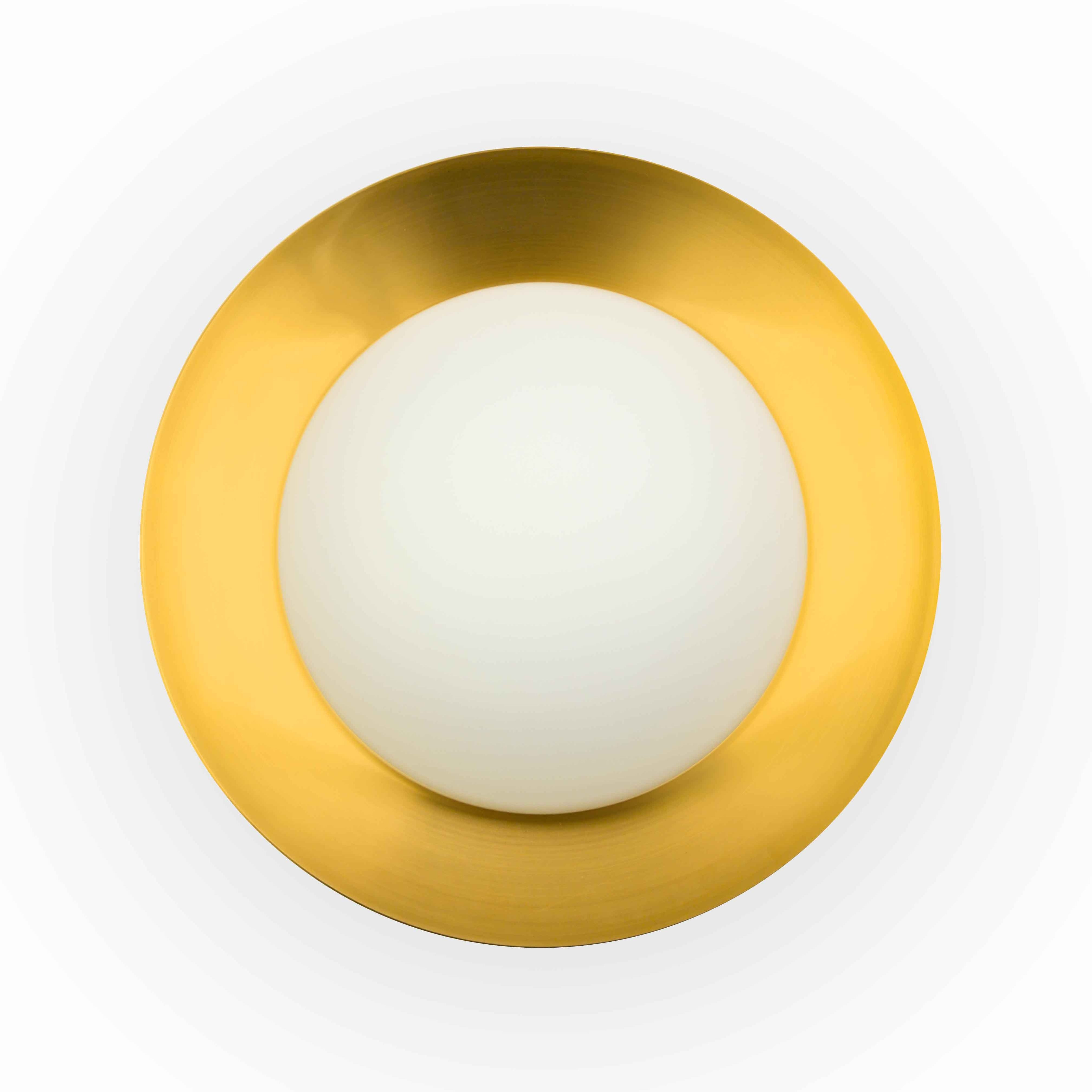 Una plafoniera color oro con un globo bianco al centro.