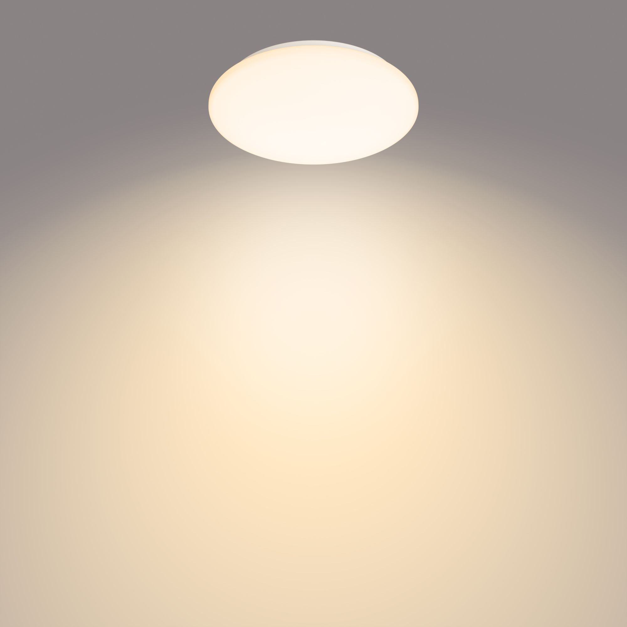 A white, round ceiling light radiating light onto a yellow-toned background.