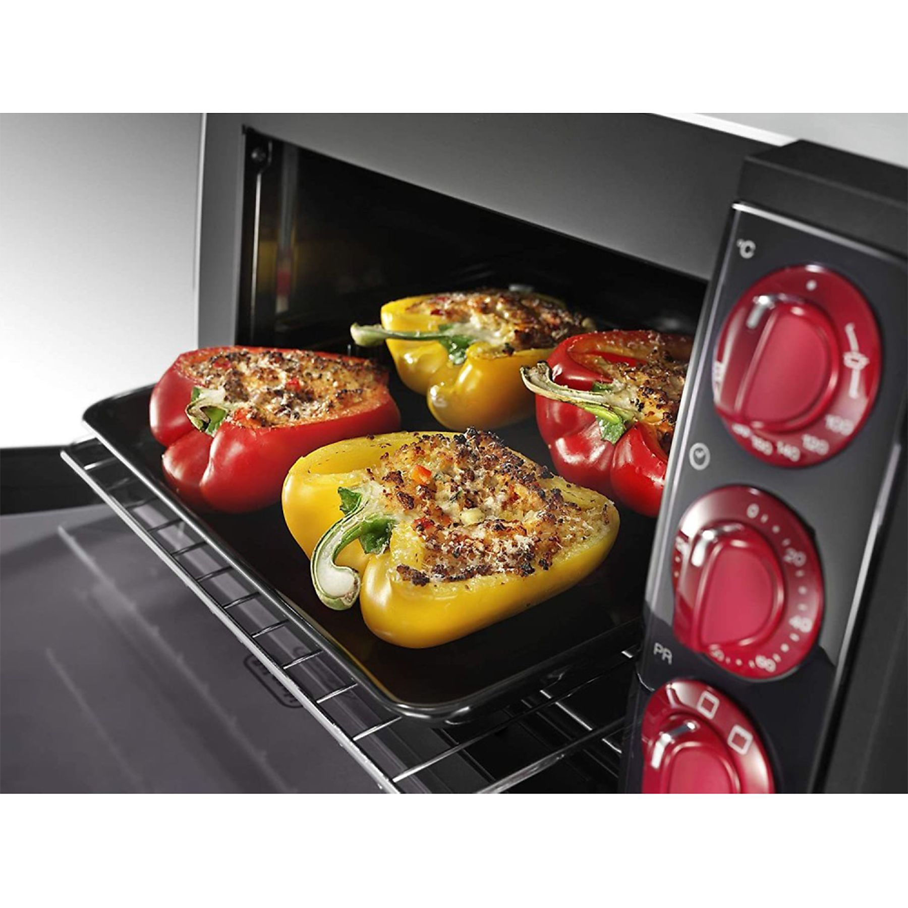 Faszerowane papryki w piekarniku, z panelem sterowania po prawej stronie.