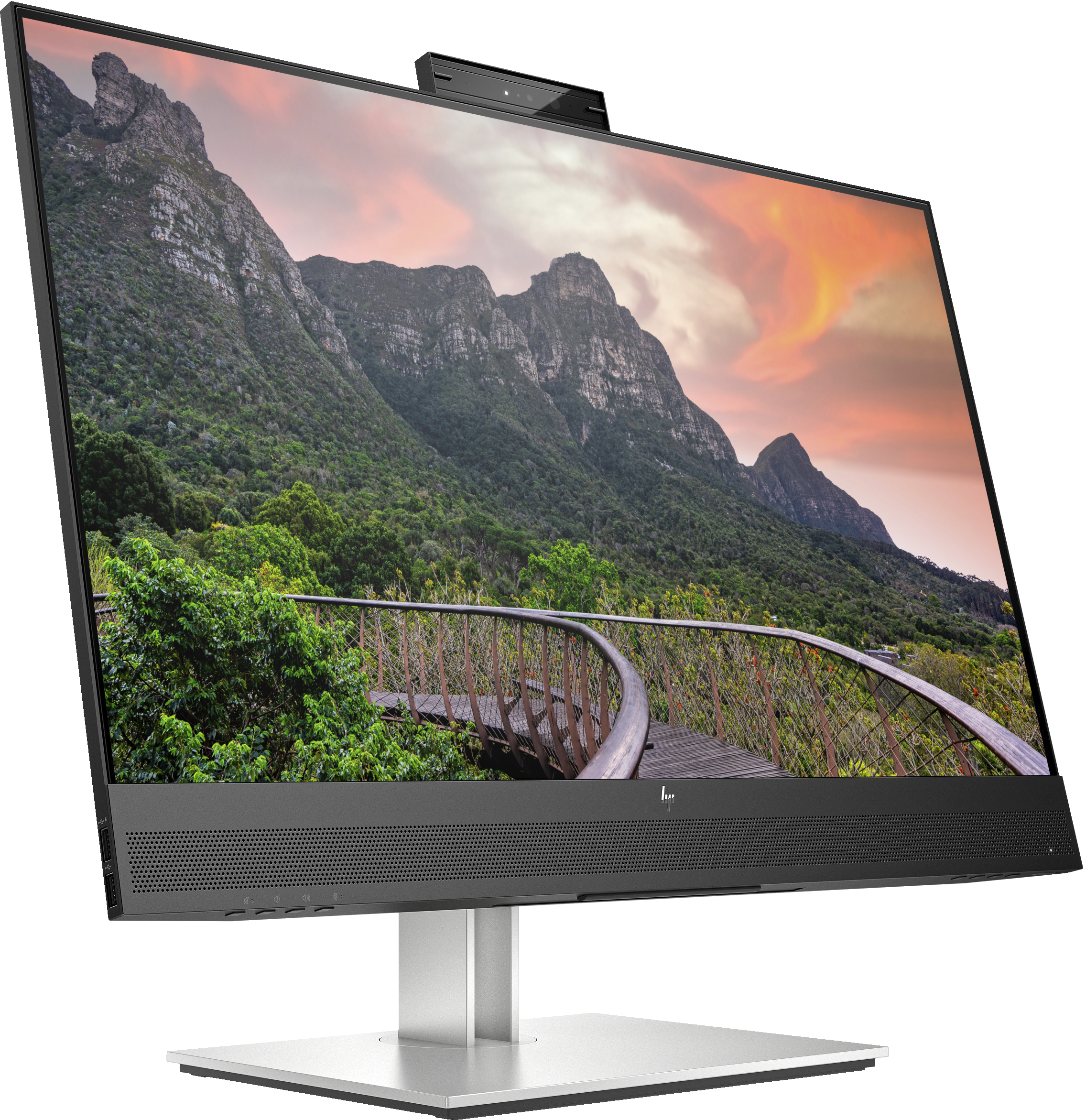 An HP monitor with a webcam, displaying a mountain scene. It's on a desk.