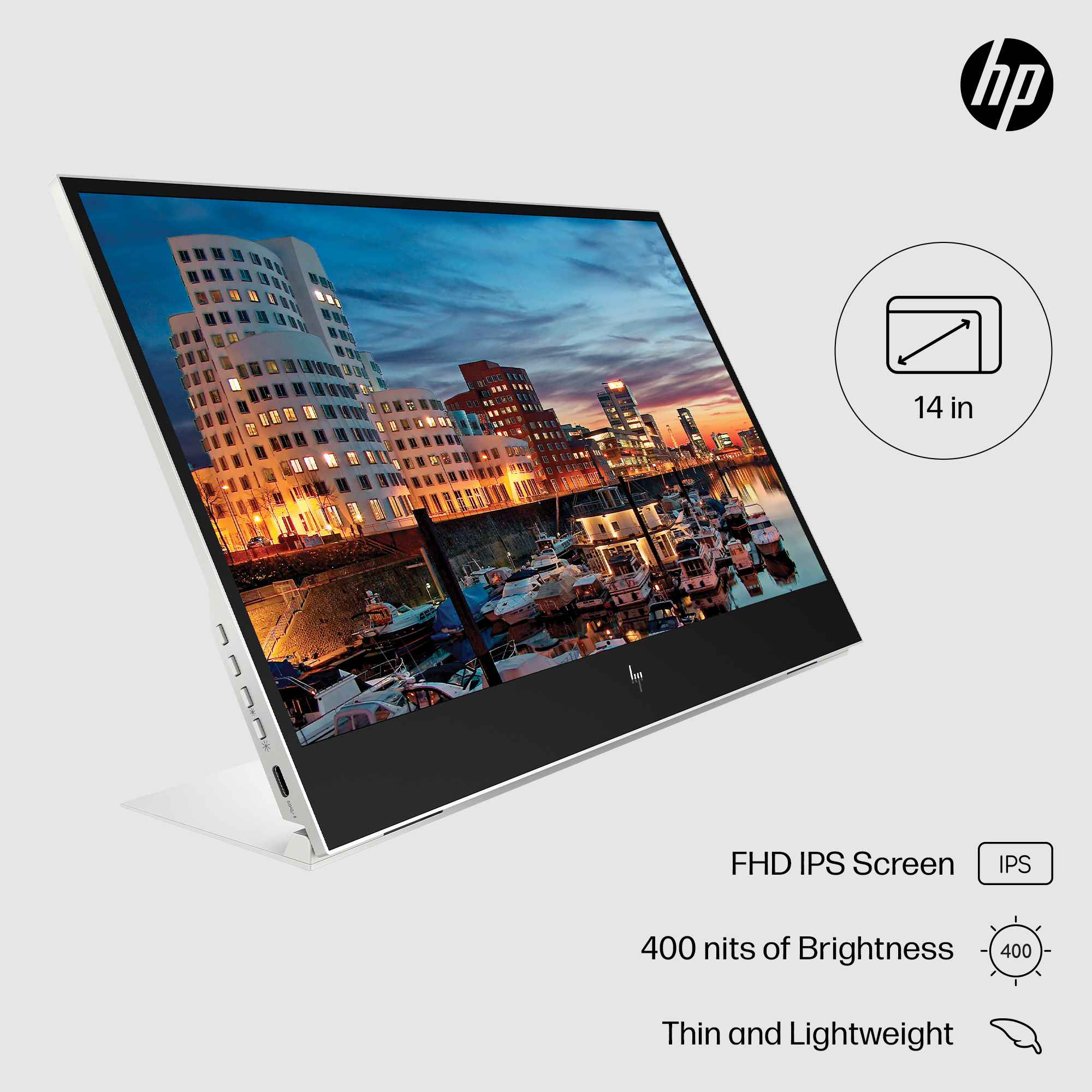 Un monitor de 14 pulgadas muestra una vista de la ciudad. Las etiquetas de información incluyen 'FHD IPS Screen' y 'Thin and Lightweight'.