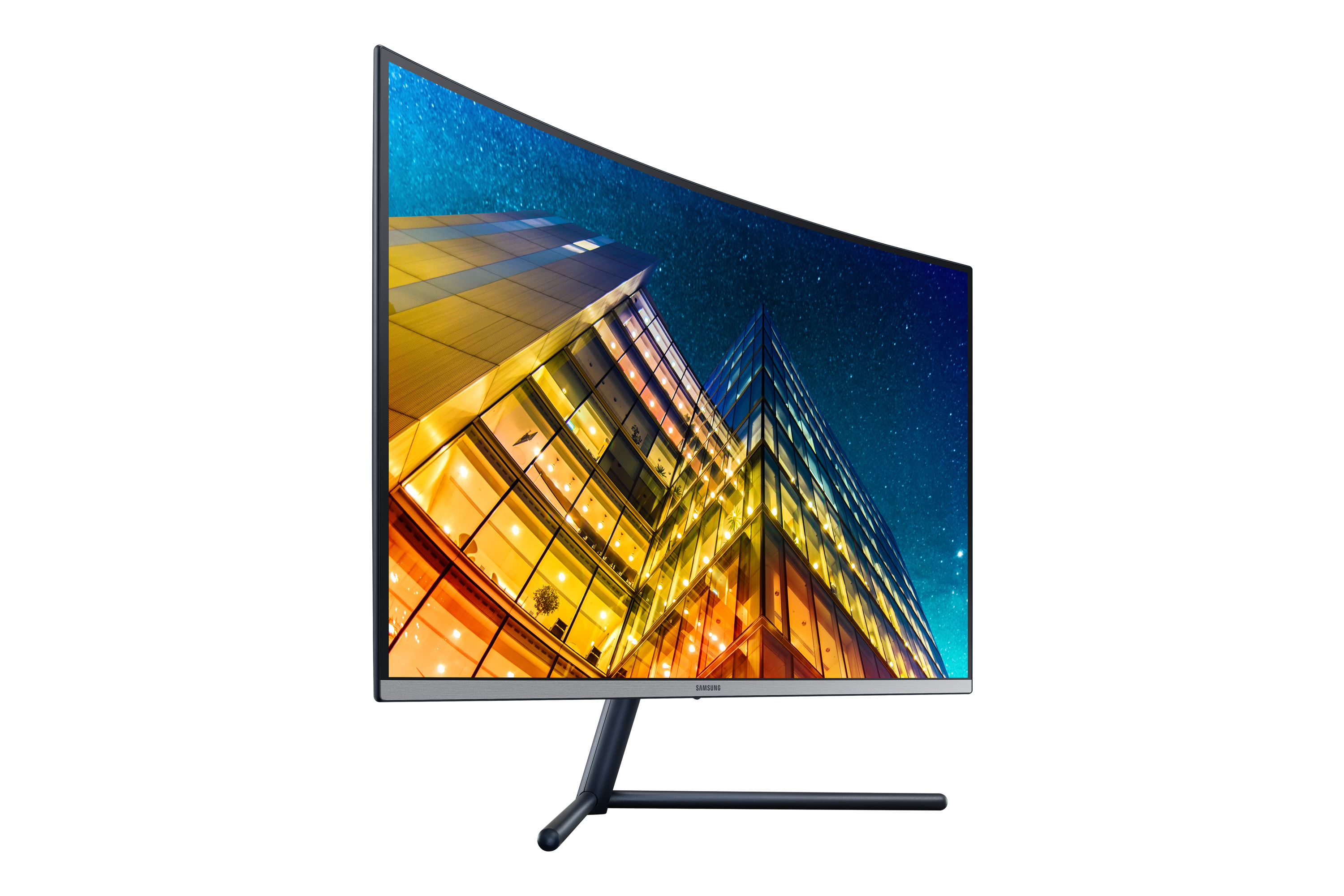 Un monitor Samsung curvo che mostra una città di notte, con un cielo stellato sullo sfondo.