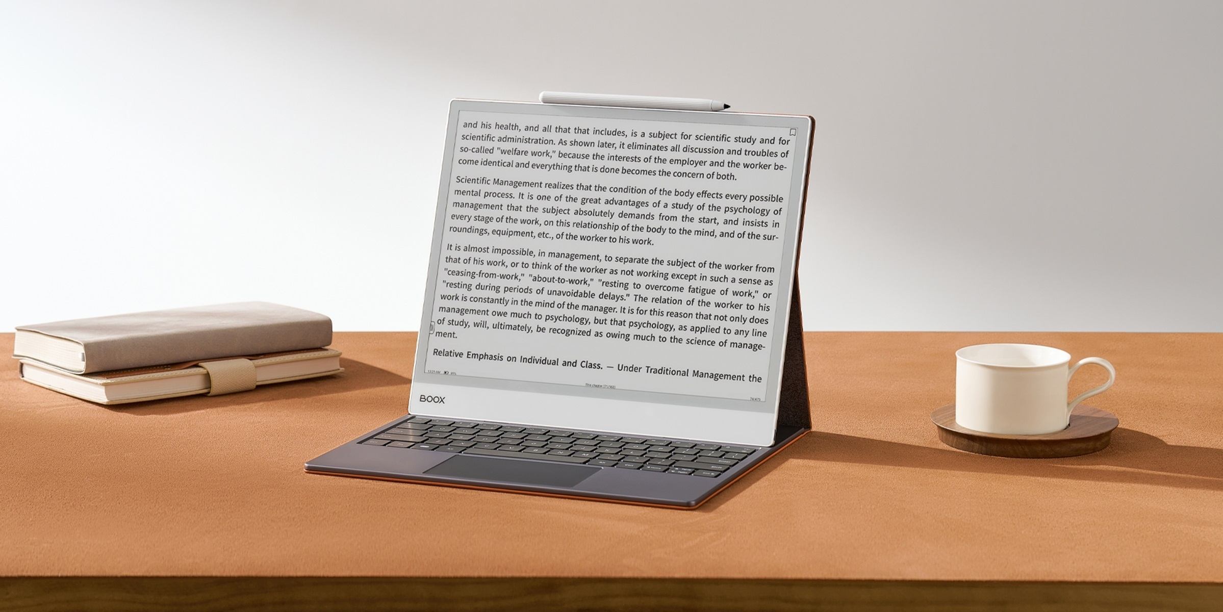 Un laptop su un tavolo di legno con libri e una tazza di caffè. Lo schermo mostra del testo.