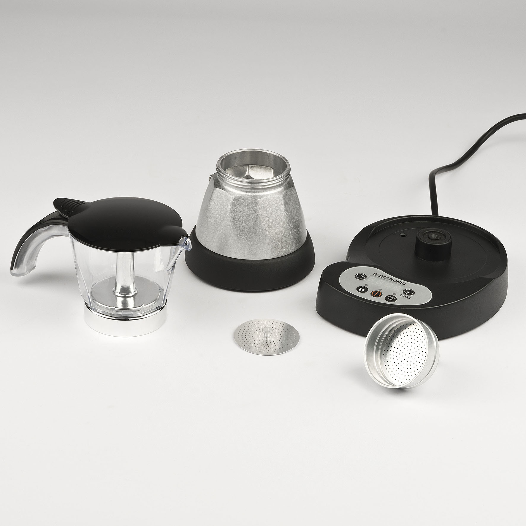 Części ekspresu do kawy: szklana karafka, filtr, podstawa i inne elementy.