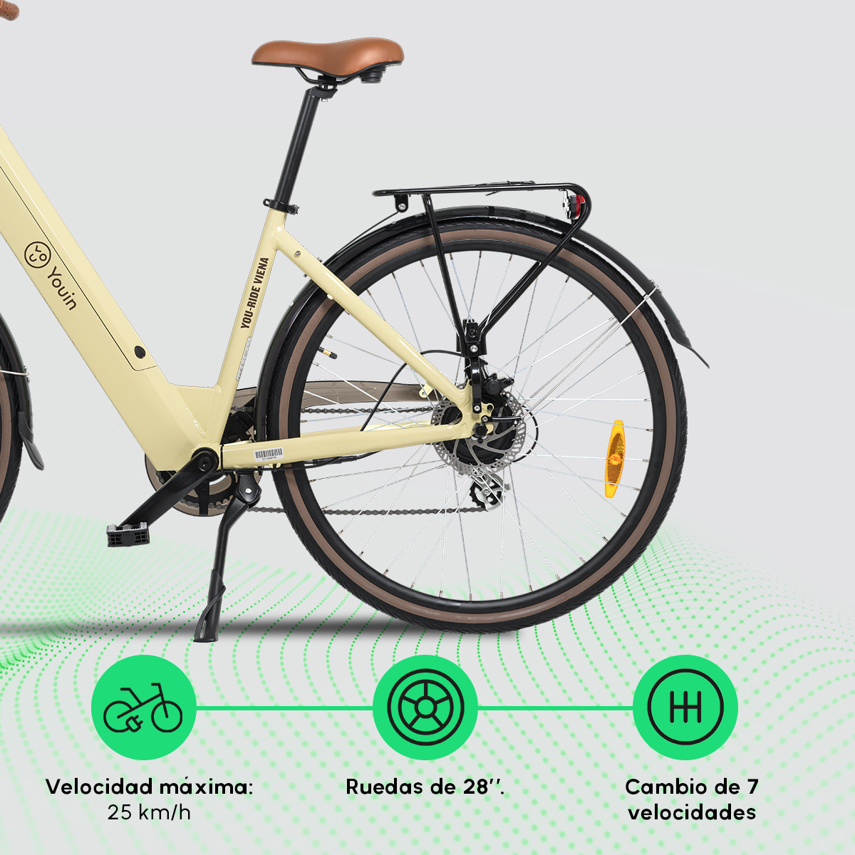 Rower z żółtą ramą, brązowymi oponami i czarnym bagażnikiem; zielona grafika.