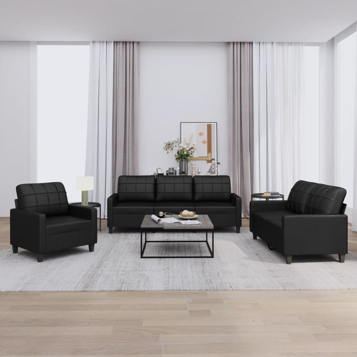 Wohnzimmerset mit schwarzem Sofa, Stühlen und einem Couchtisch.