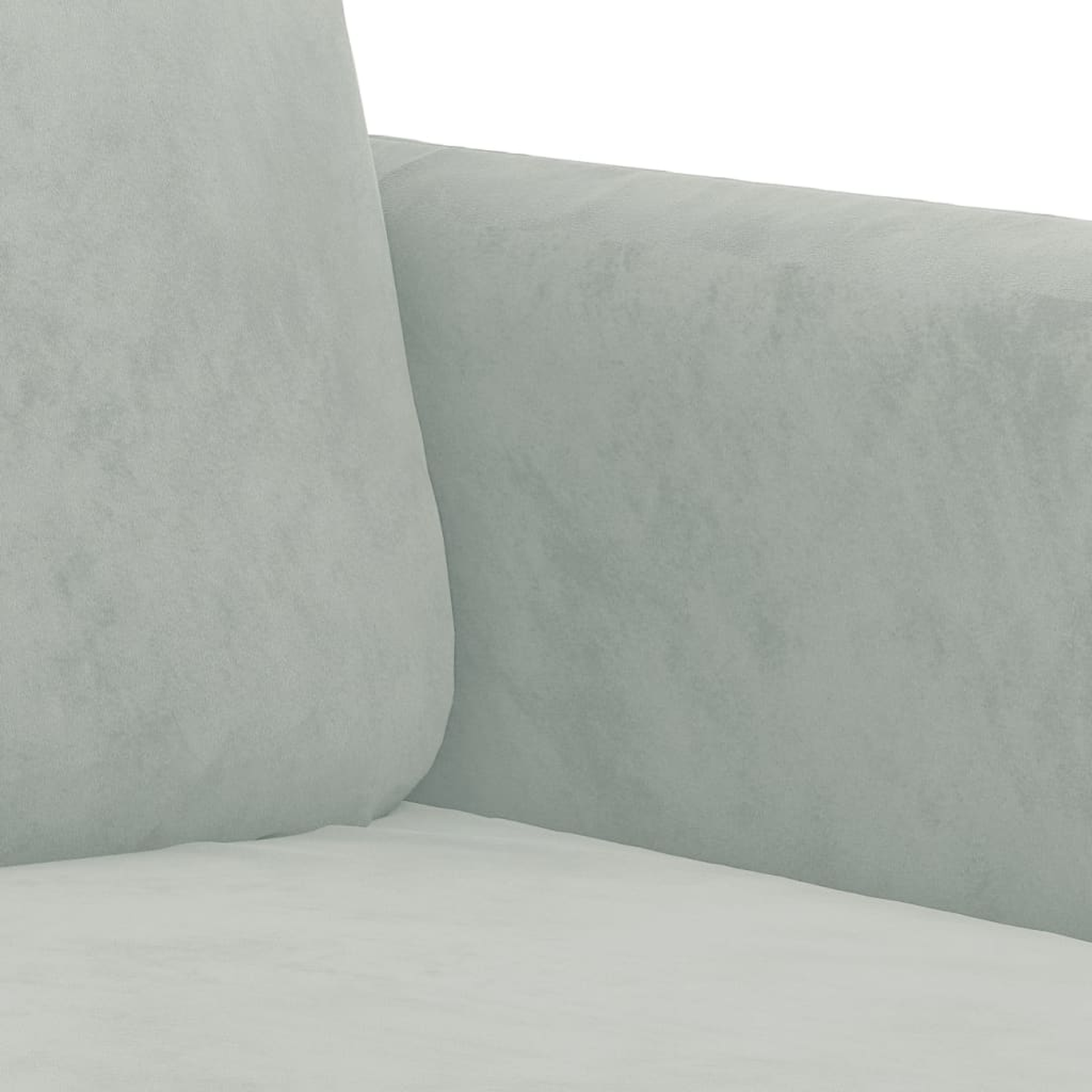 Nahaufnahme eines hellgrauen Sofas, Arm und Kissen verschmelzen sanft.